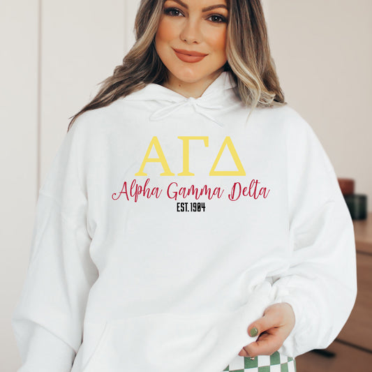 a woman wearing a white hoodie with a yellow and red letters on it