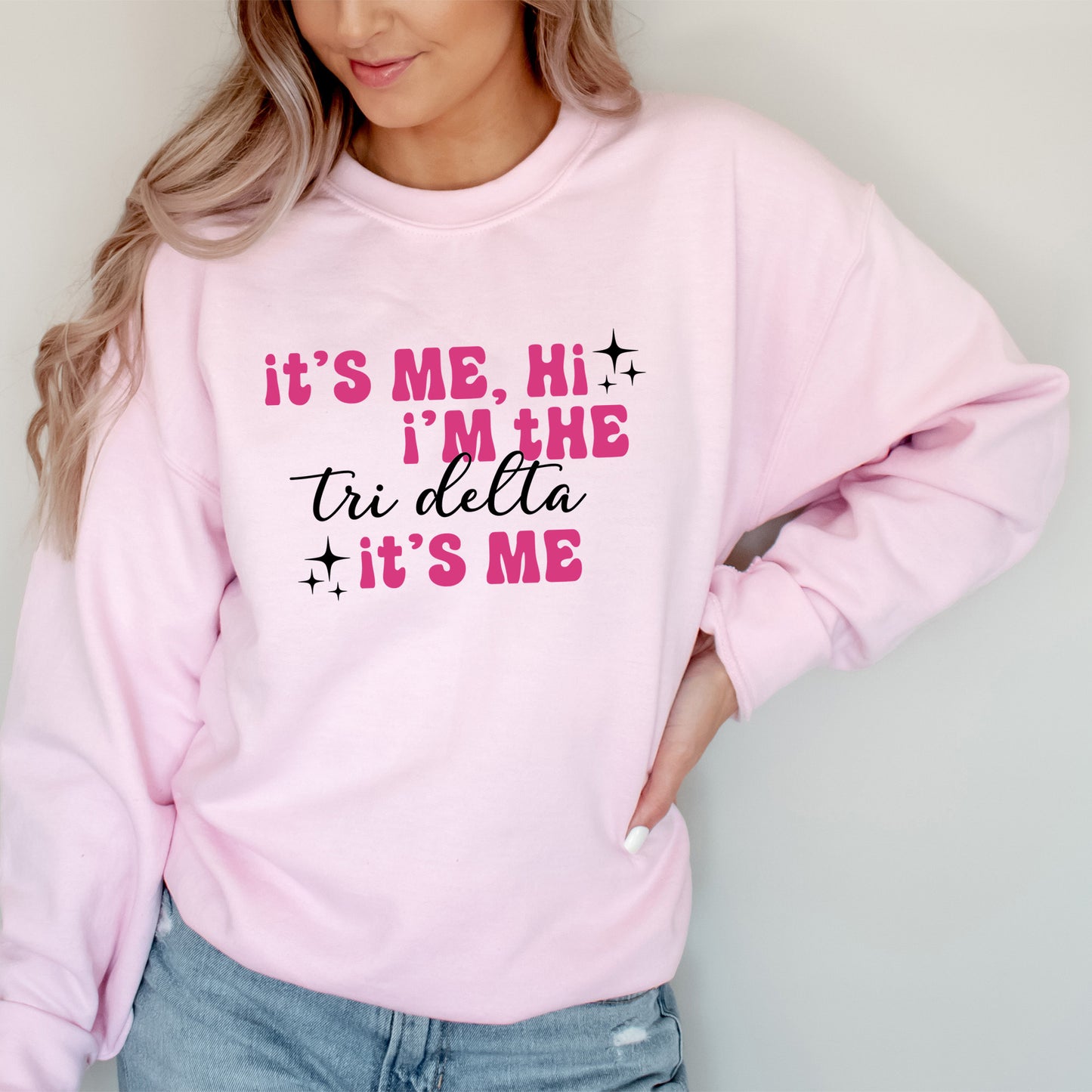 a woman wearing a pink sweatshirt that says it's me, i'm