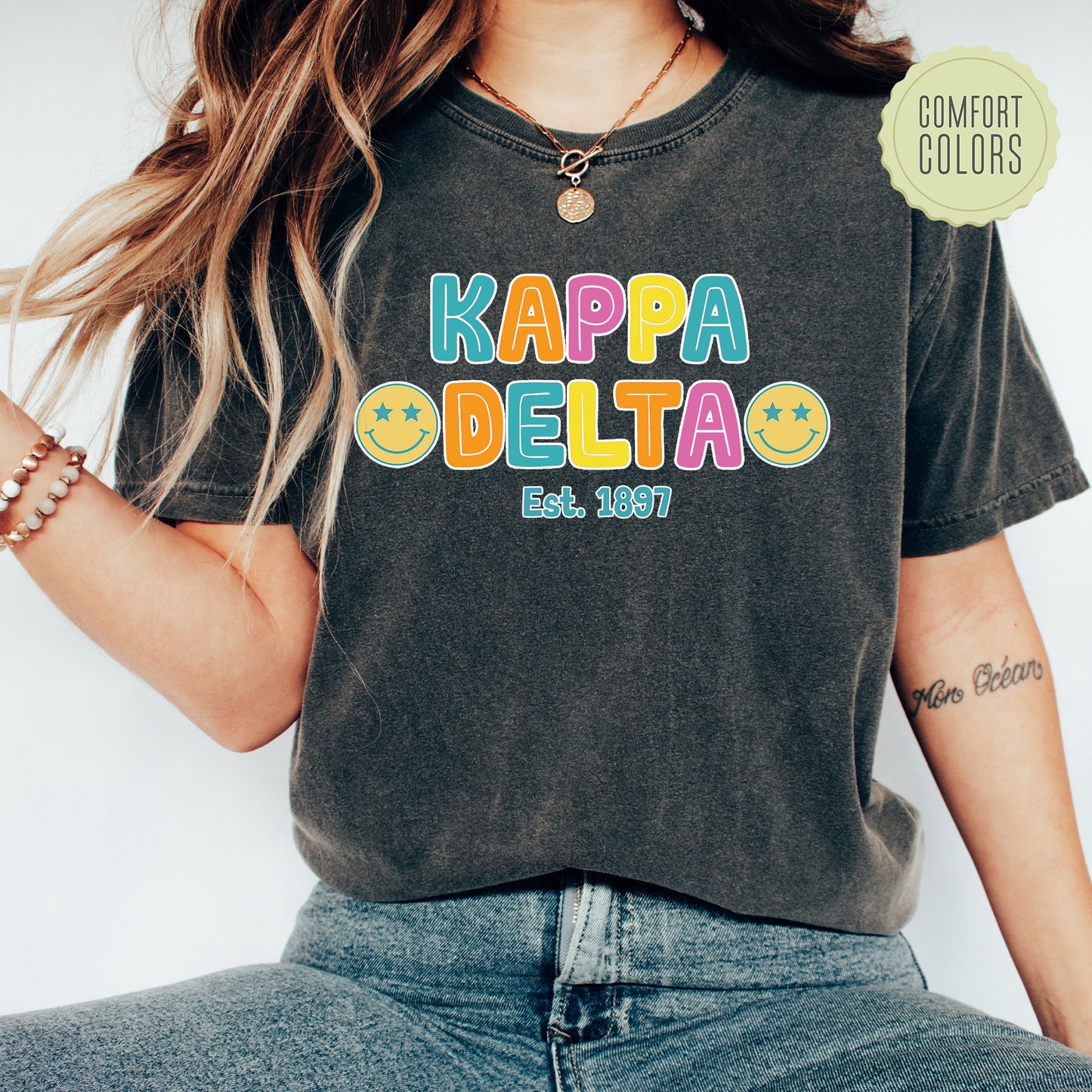 a woman wearing a t - shirt that says kappa delta