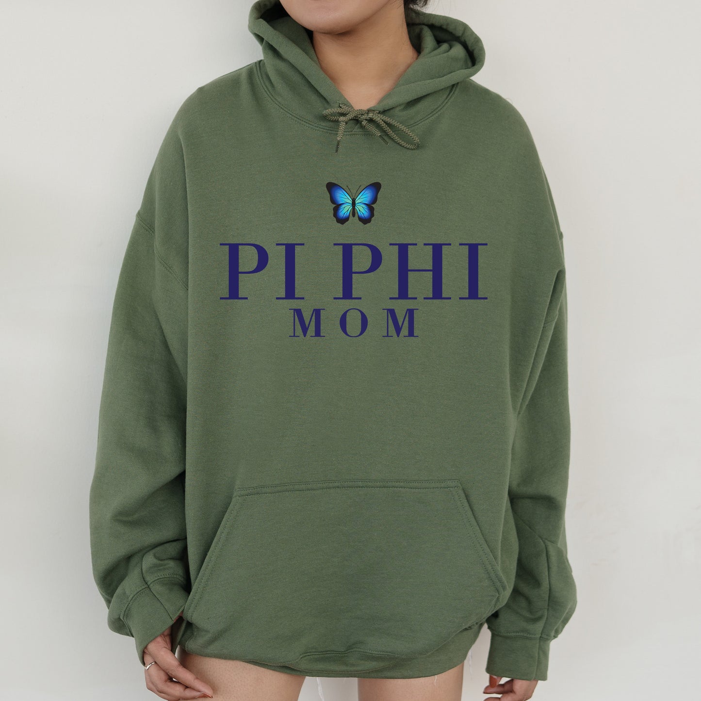 a woman wearing a green hoodie with a butterfly on it