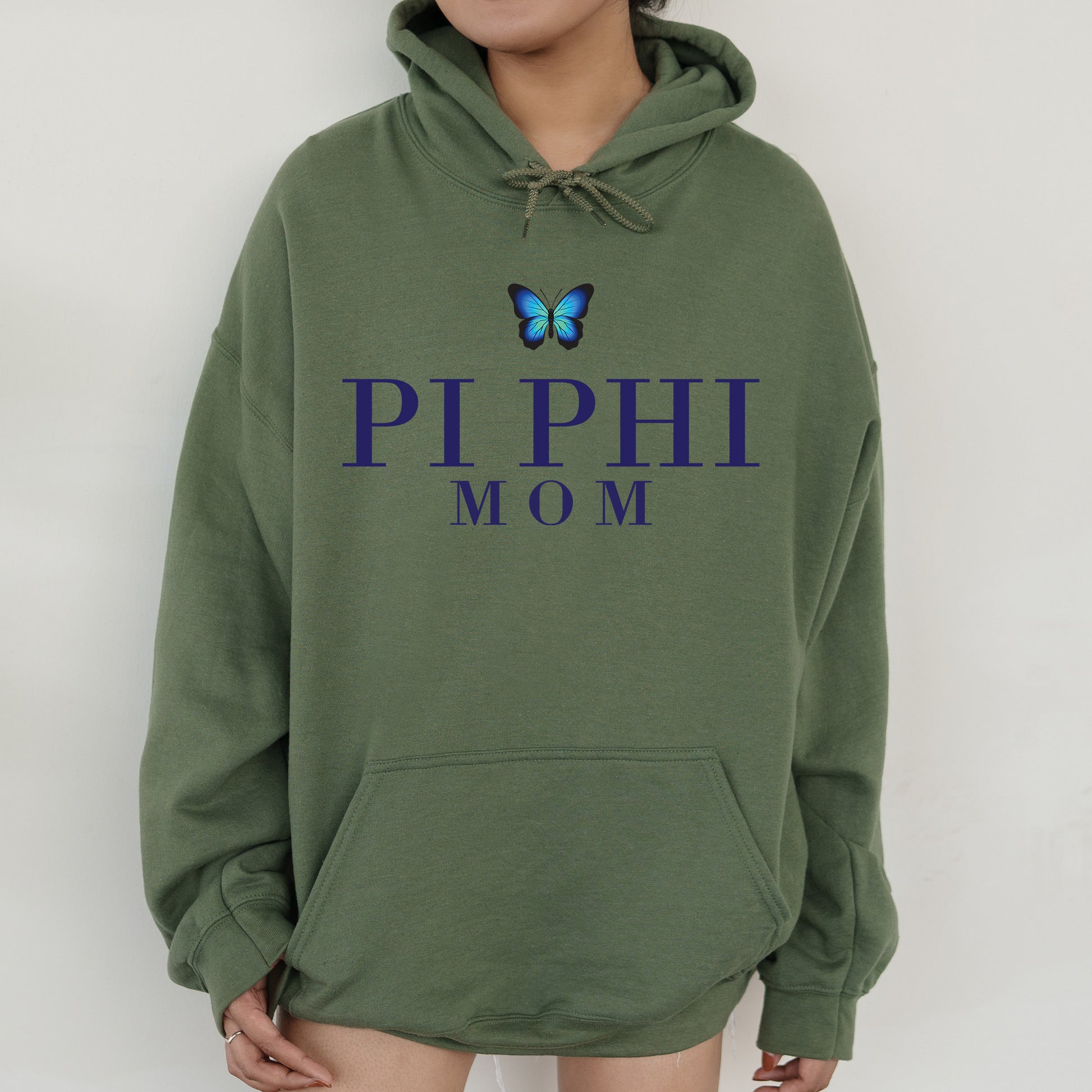 a woman wearing a green hoodie with a butterfly on it