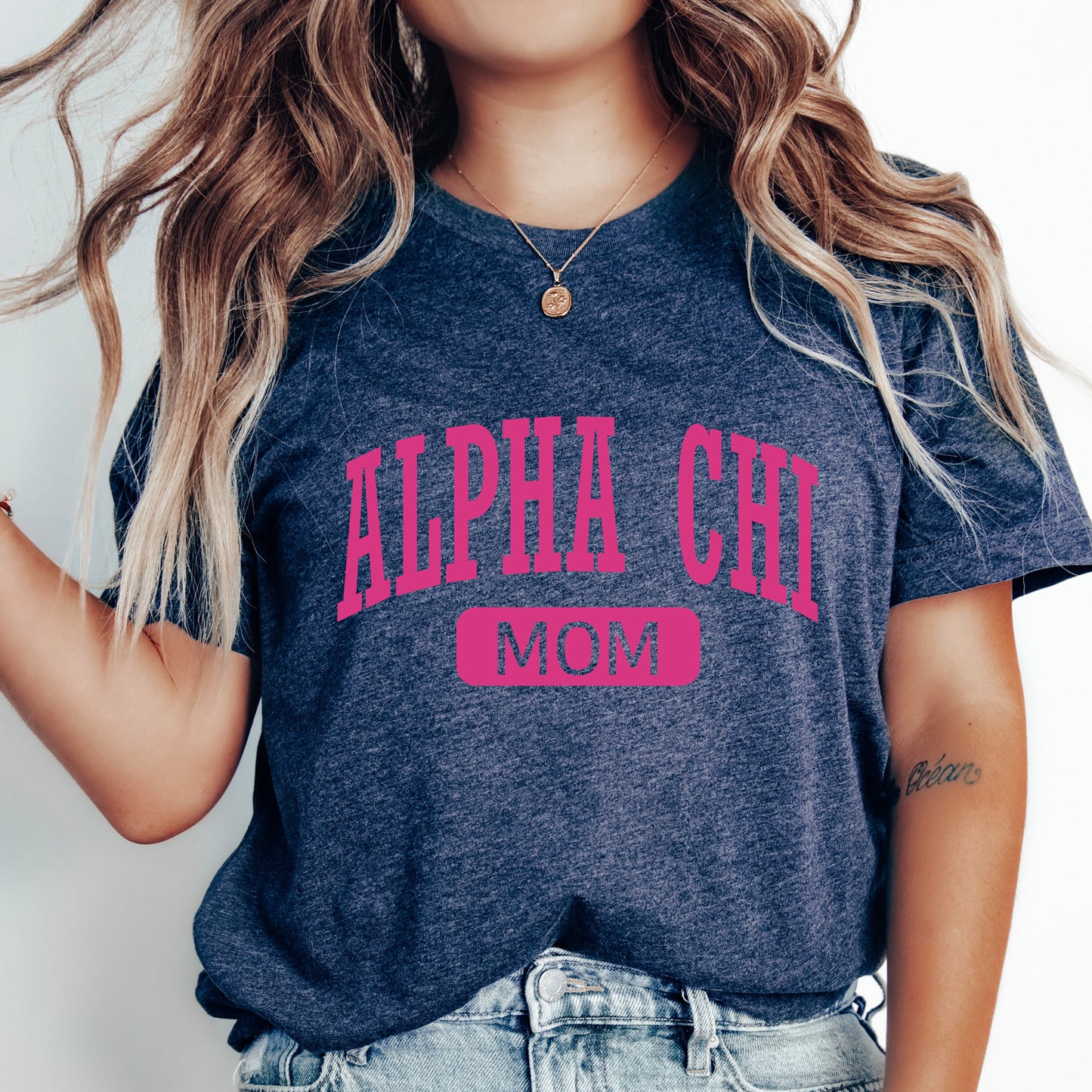 a woman with long hair wearing a shirt that says alphia girl mom