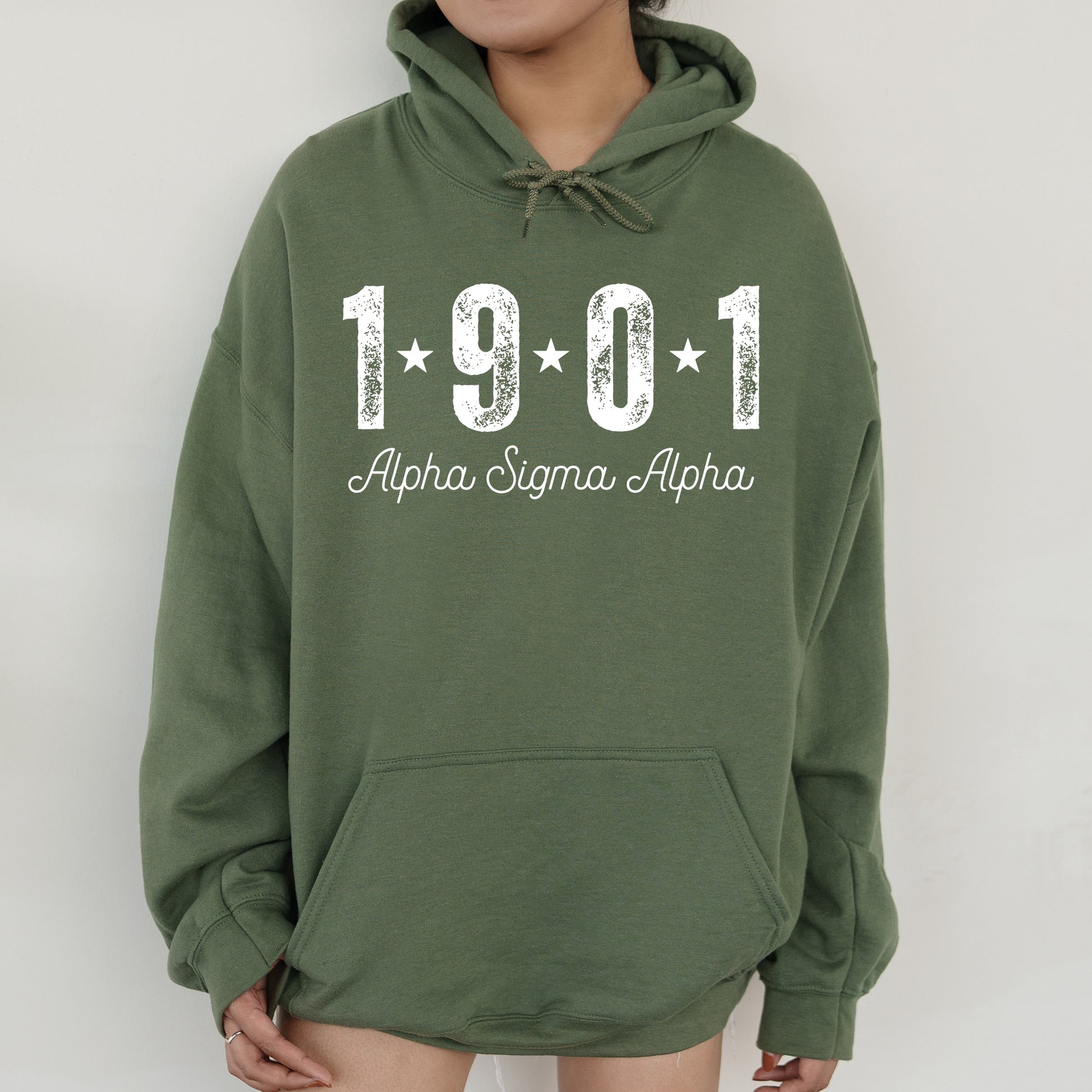 a woman wearing a green hoodie with the number 1911 printed on it