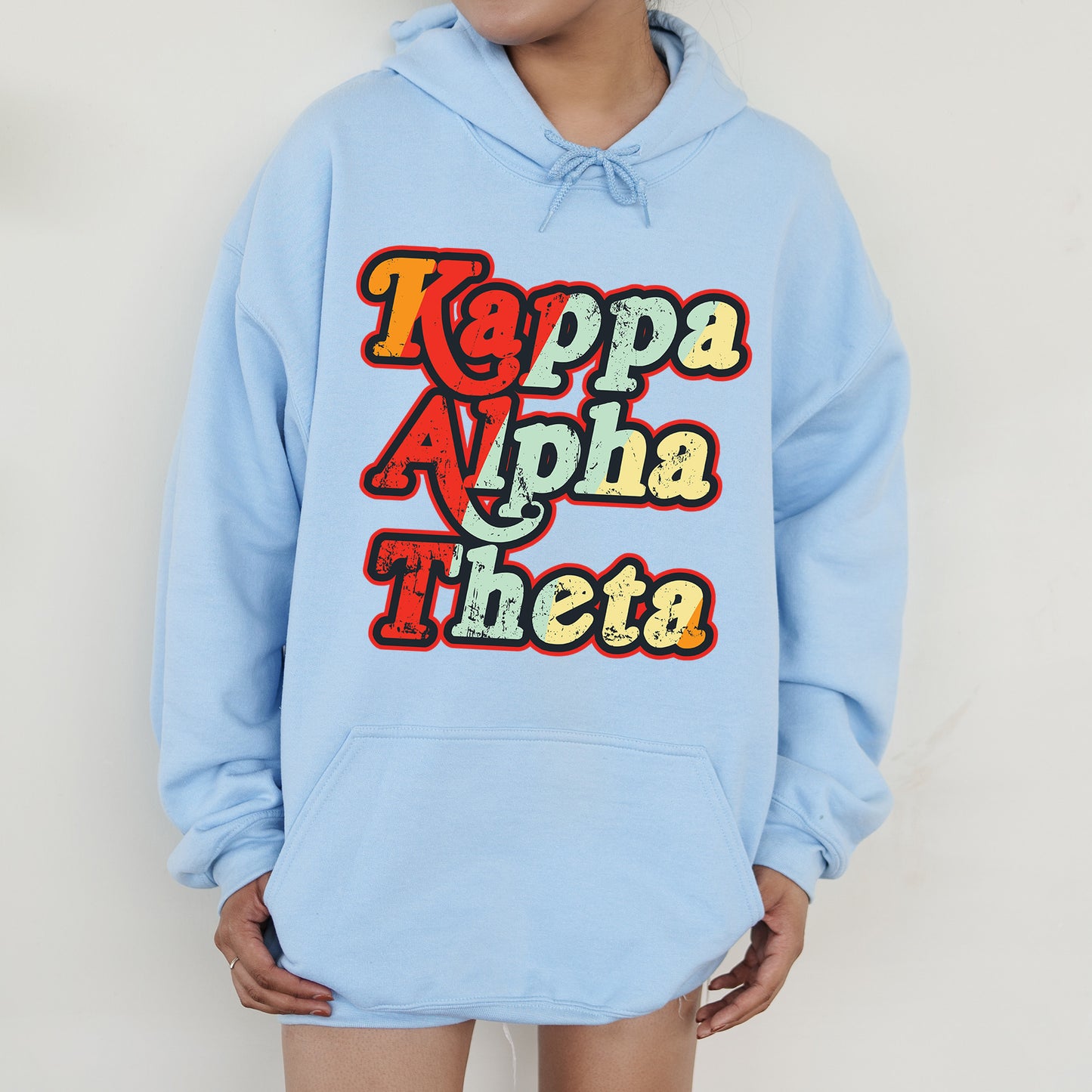a person wearing a blue hoodie that says kappa aha theea