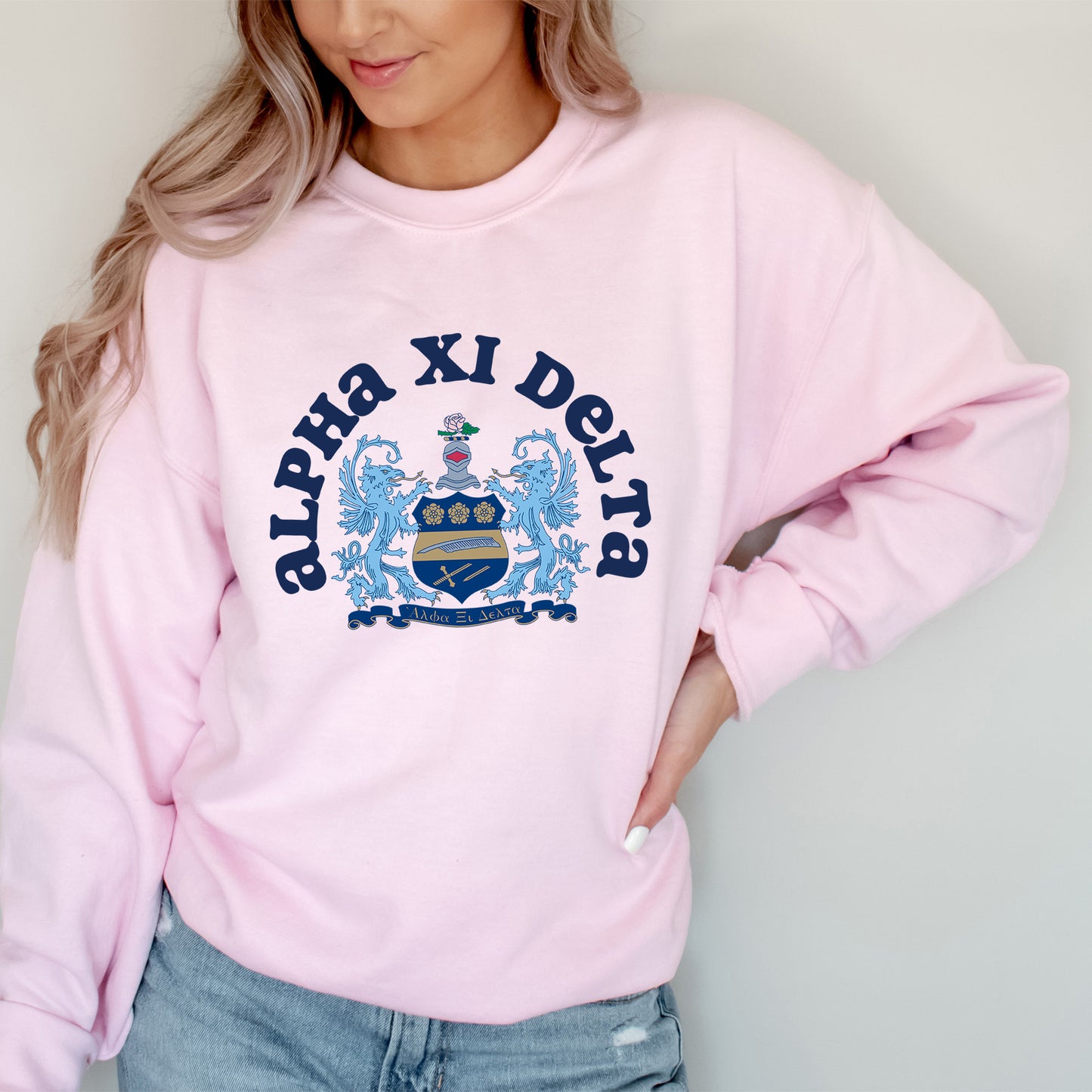 a woman wearing a pink sweatshirt and jeans