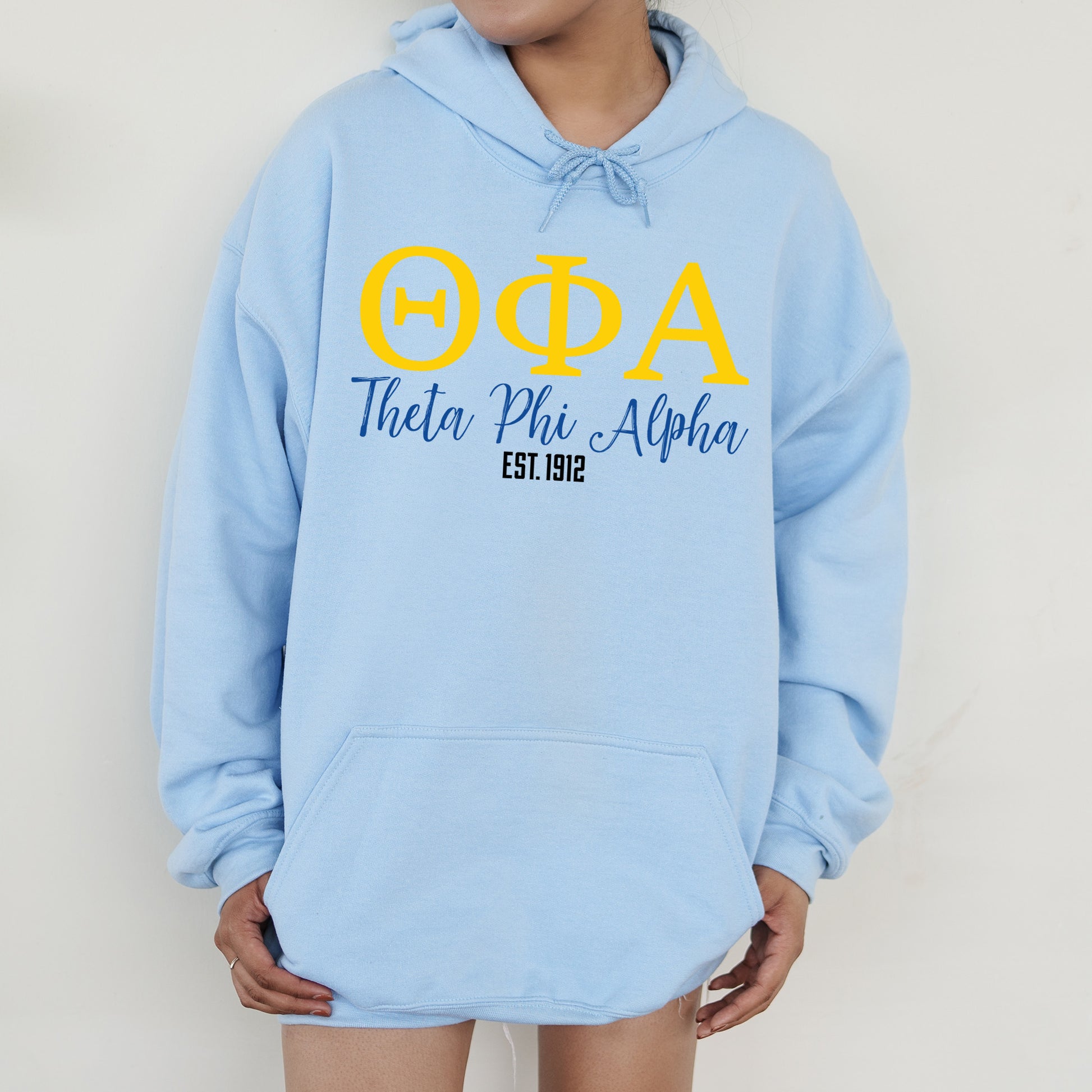 a person wearing a blue hoodie with yellow letters on it