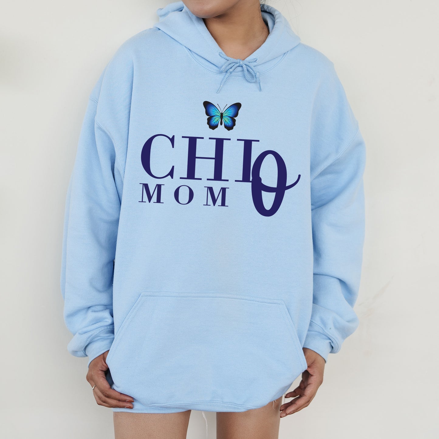 a woman wearing a blue hoodie with a butterfly on it