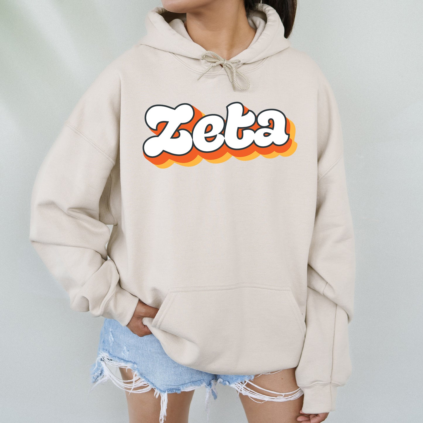 a woman wearing a sweatshirt with the word zetta on it