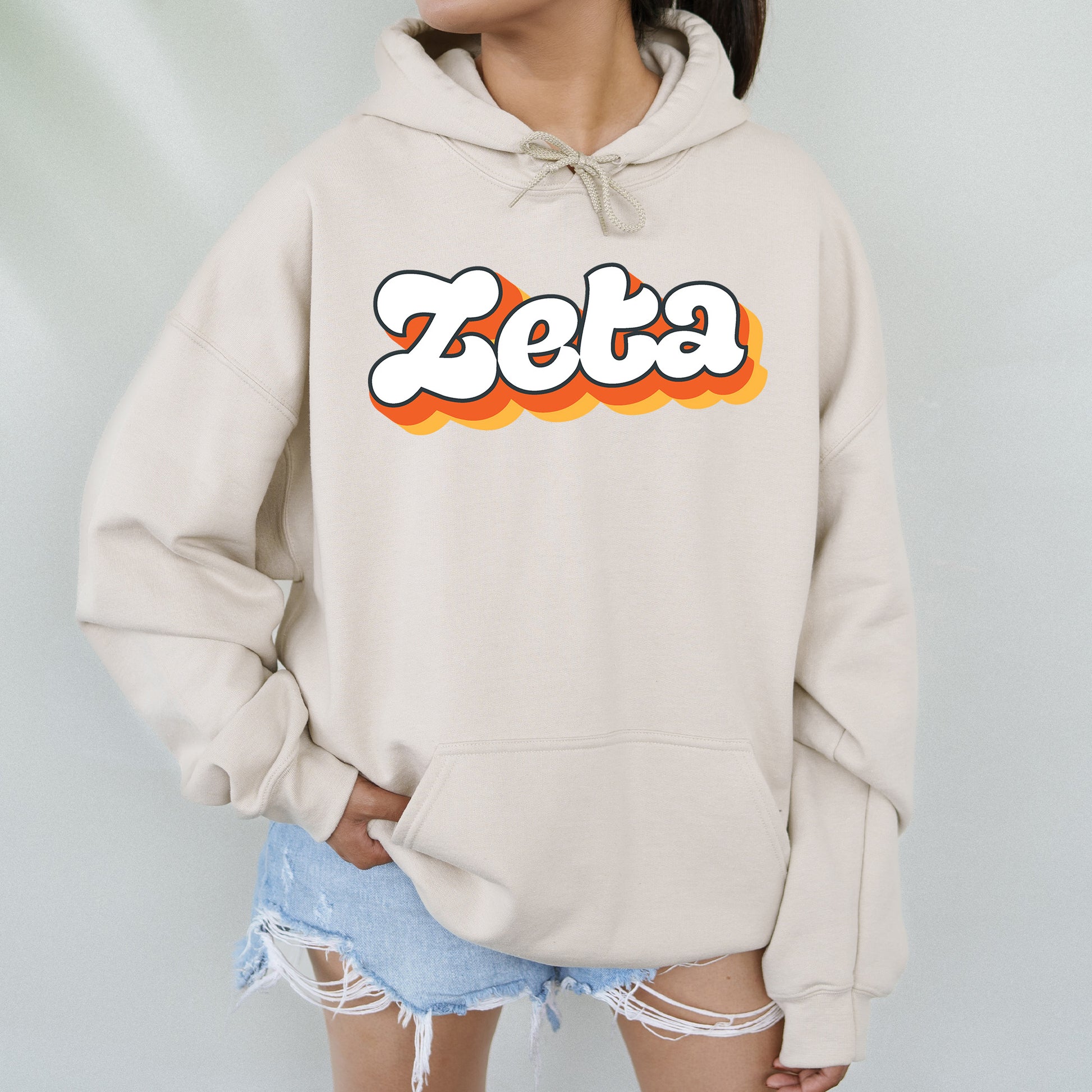 a woman wearing a sweatshirt with the word zetta on it
