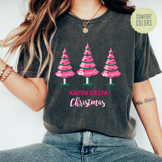 a woman wearing a t - shirt that says karp delta christmas trees