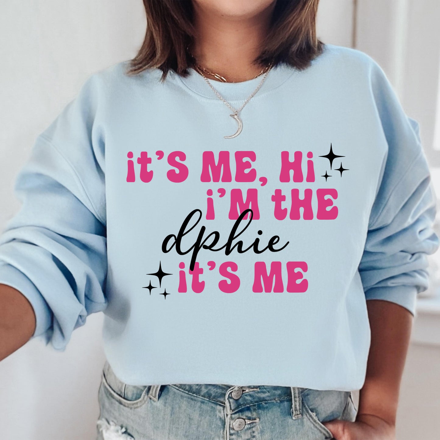 a woman wearing a blue sweatshirt that says it's me, i'm