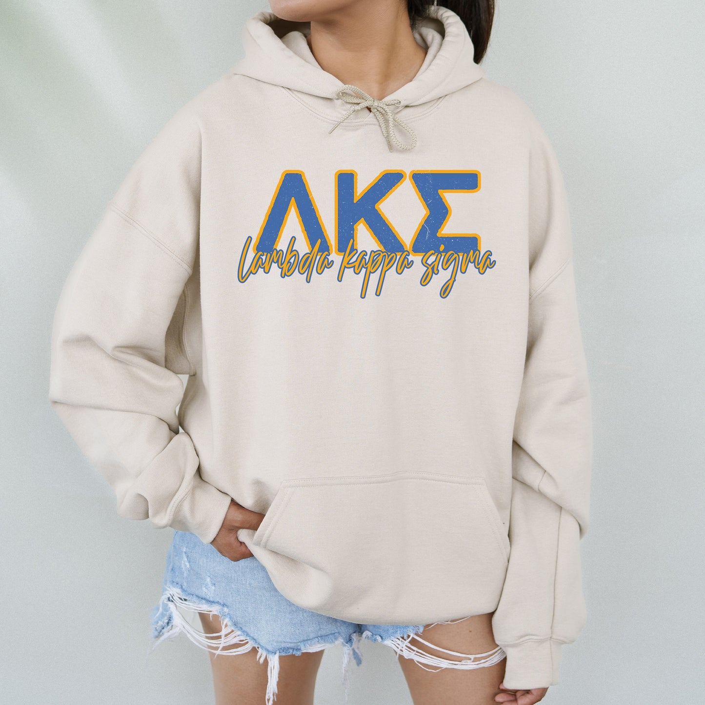 a woman wearing a sweatshirt with the letters ake on it