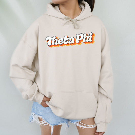 a woman wearing a sweatshirt that says thea phi