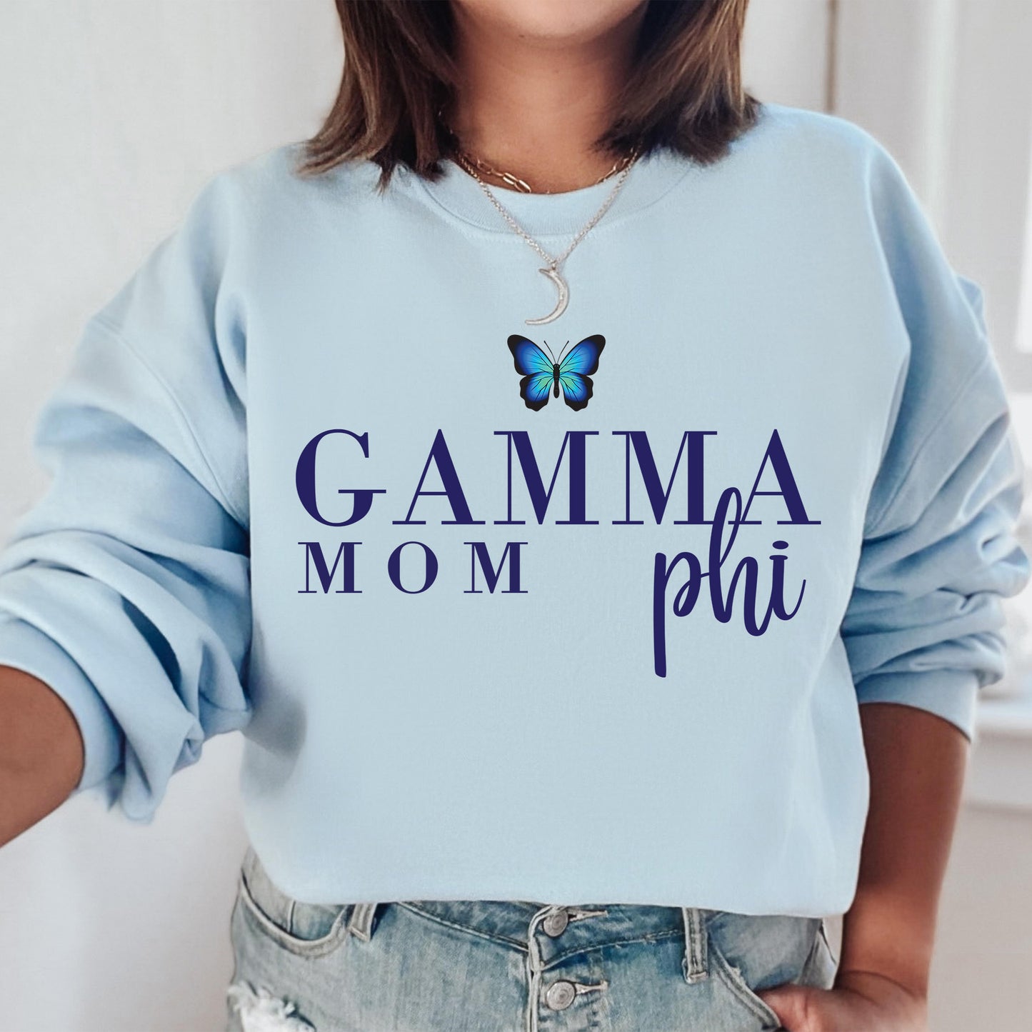 a woman wearing a blue sweatshirt with a butterfly on it