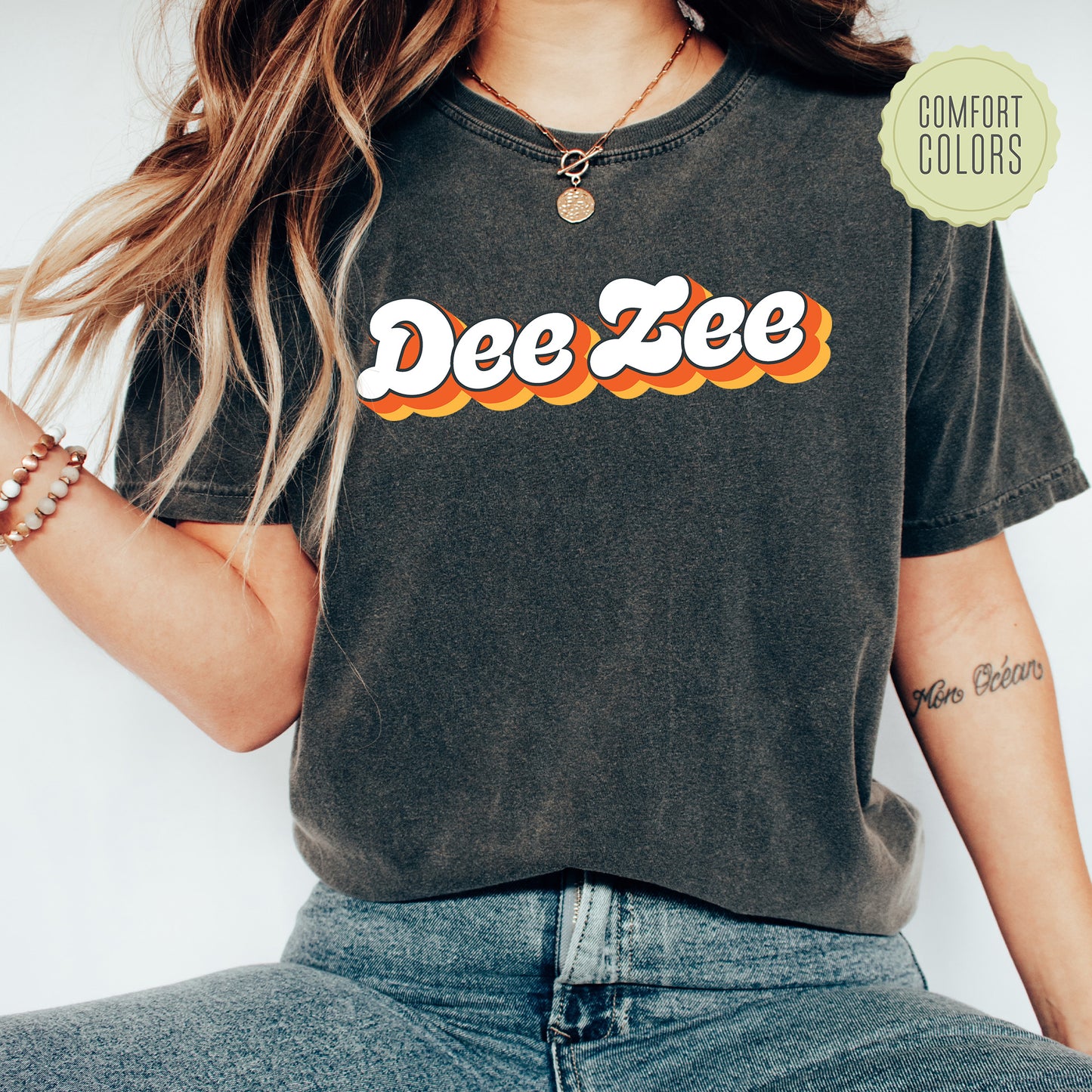 a woman wearing a tee shirt with the word dee zee on it