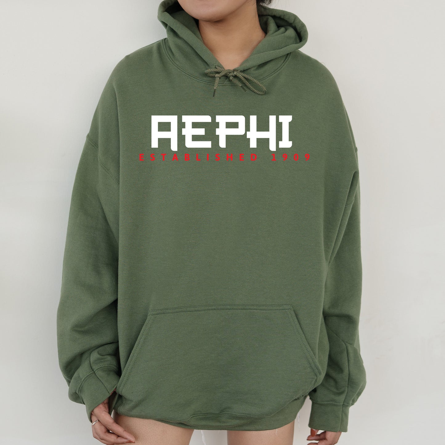 a person wearing a green hoodie with the word aeph on it