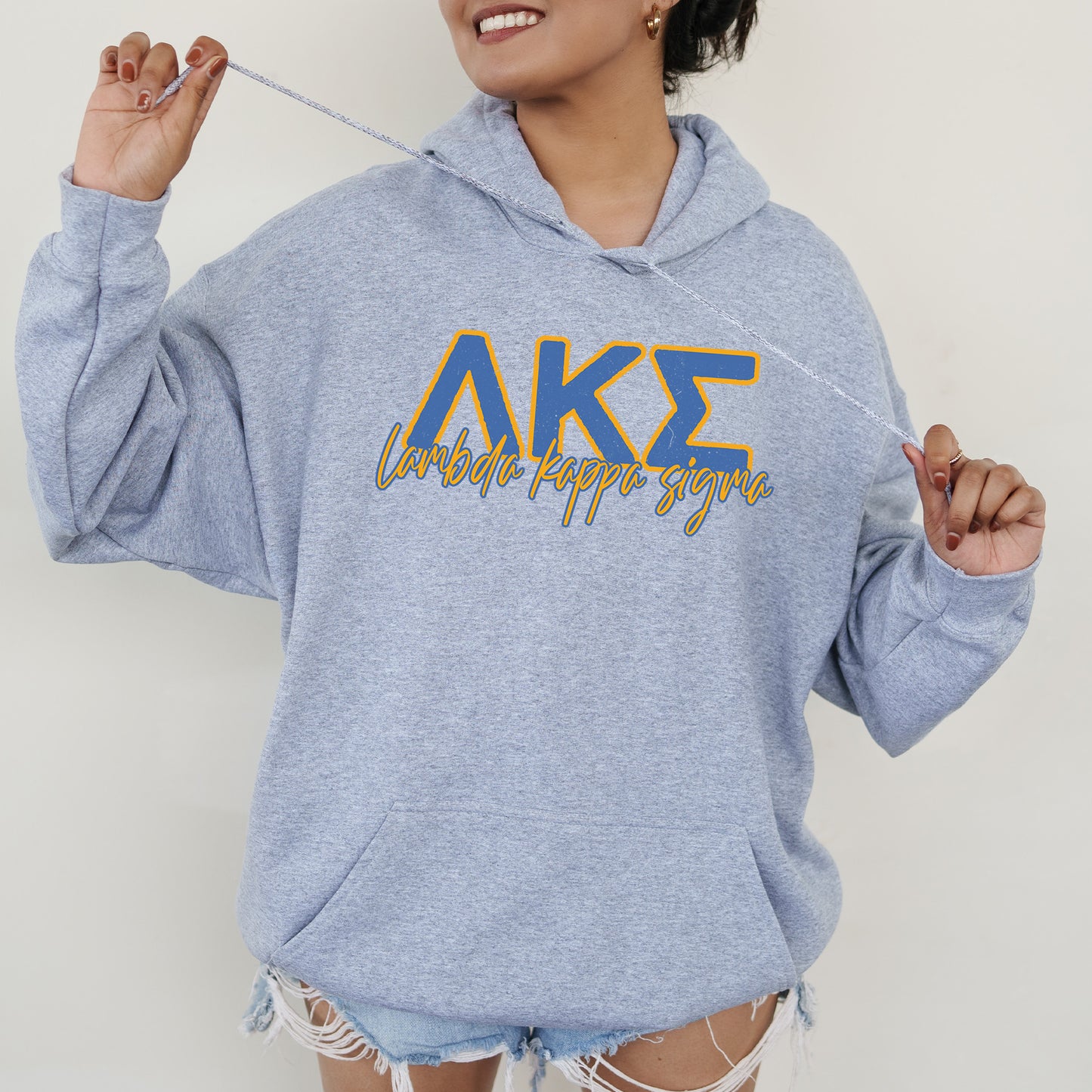 a woman in a blue hoodie holding a toothbrush