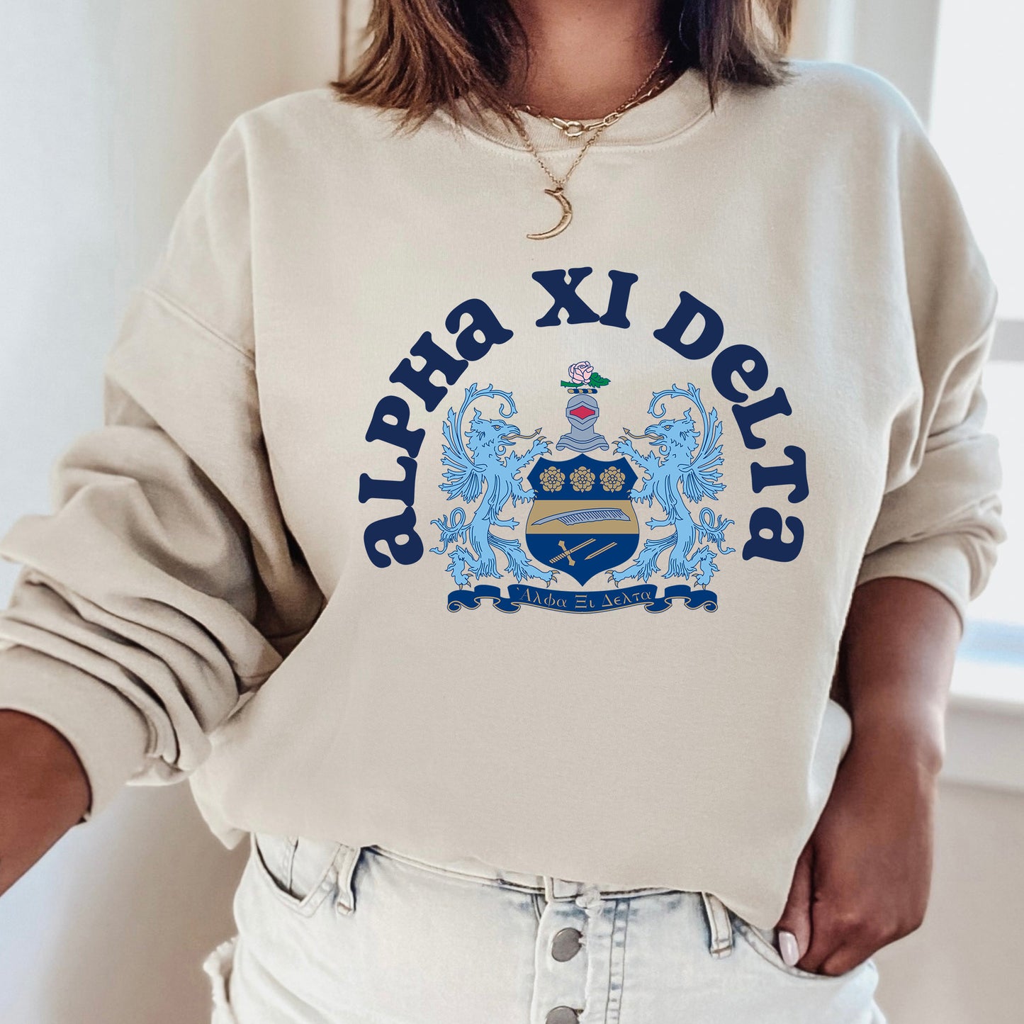 a woman wearing a sweatshirt with a crest on it