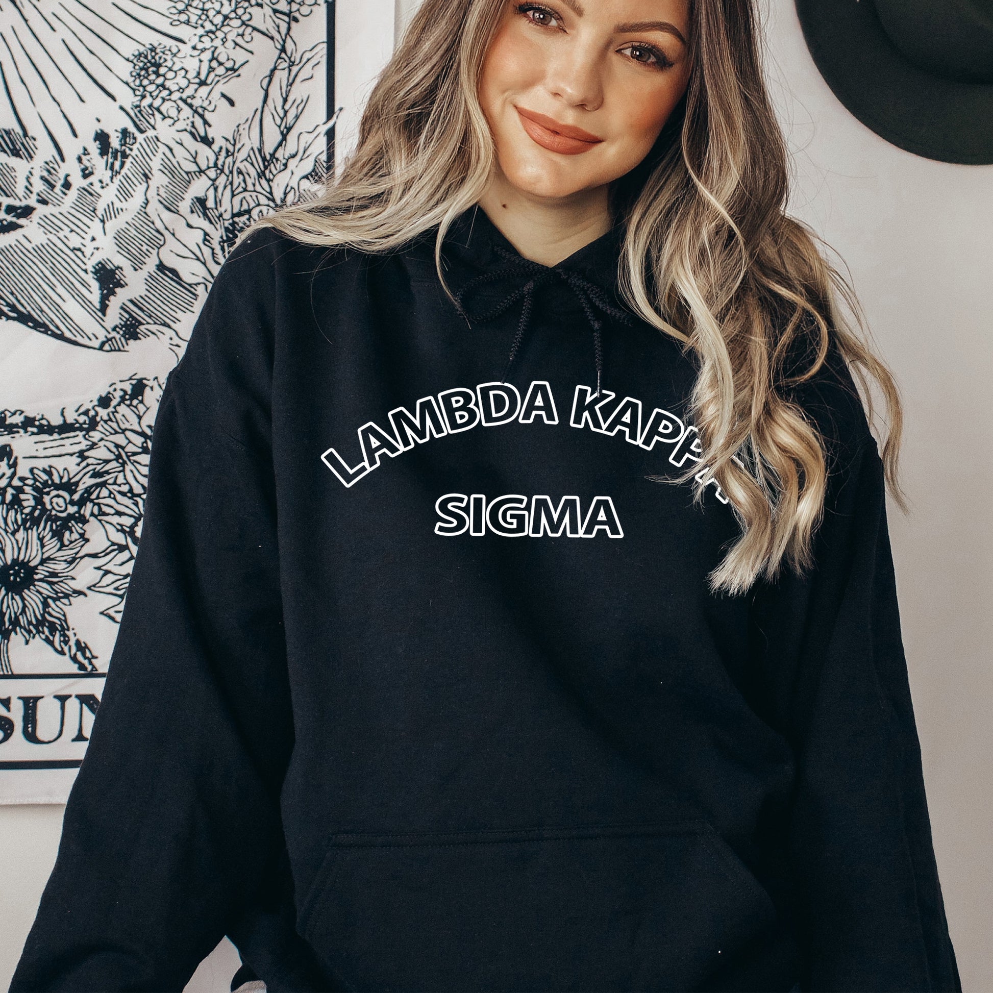 a woman wearing a black hoodie that says lambda karp stigma