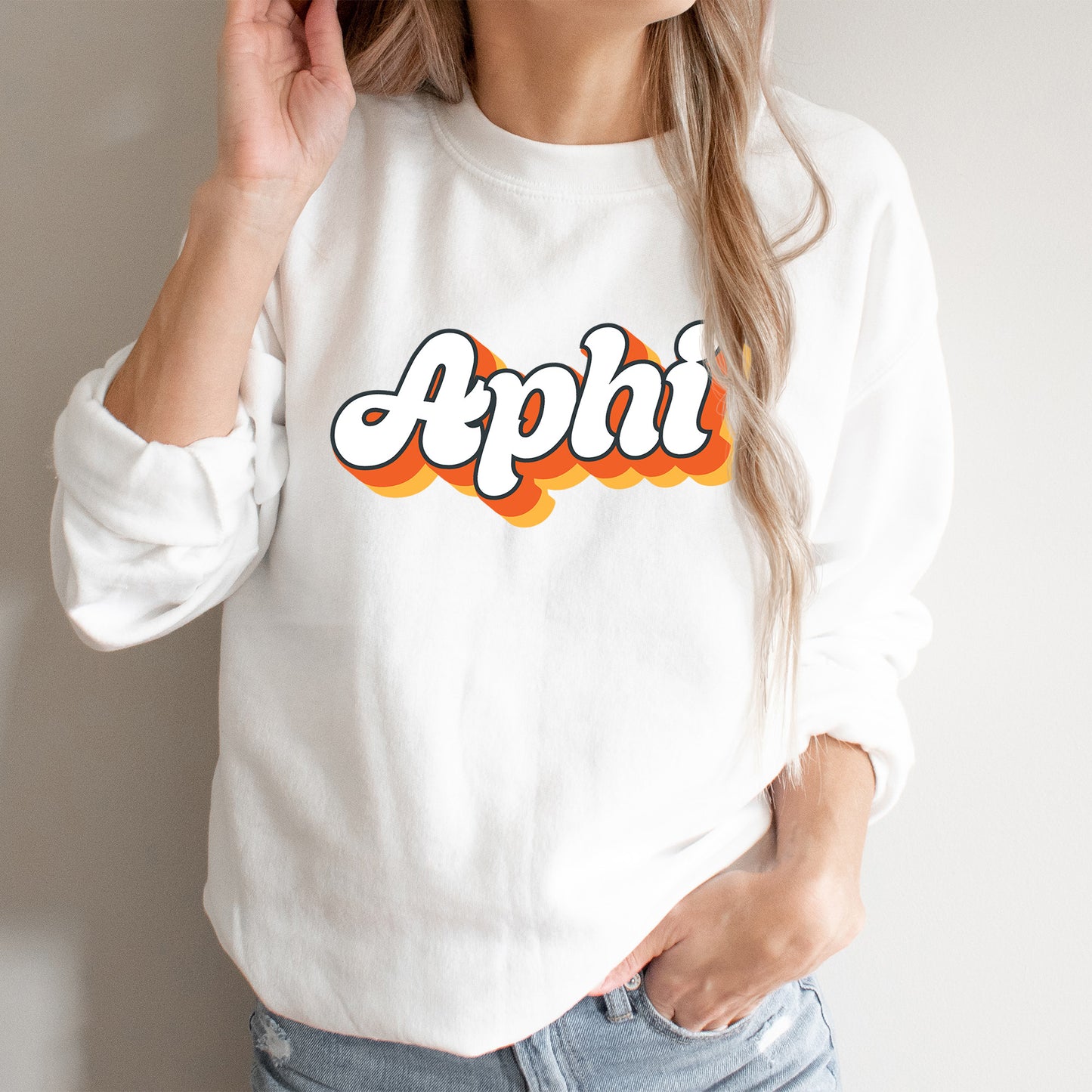 a woman wearing a white sweatshirt with the word apphi on it