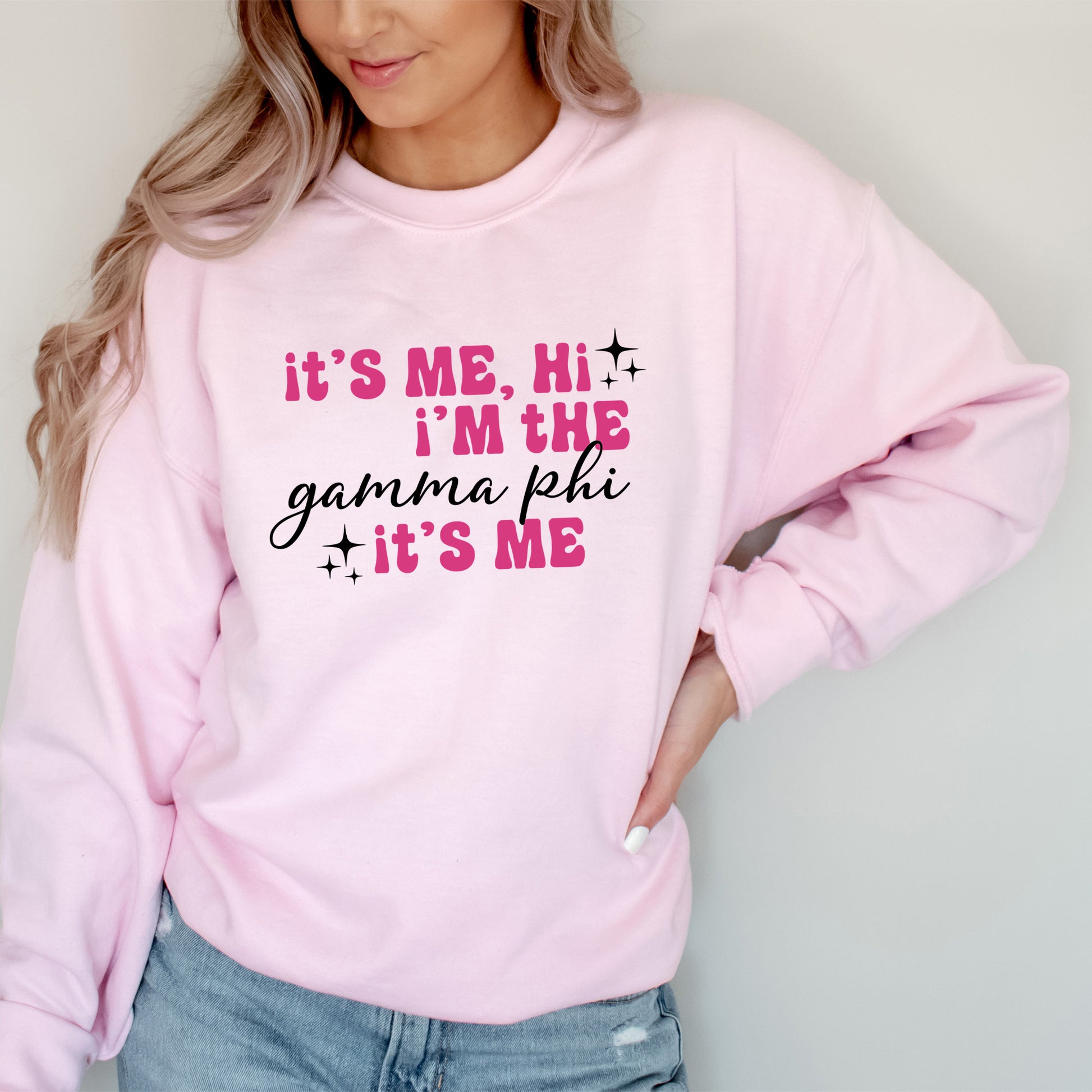 a woman wearing a pink sweatshirt that says it's me, i'm