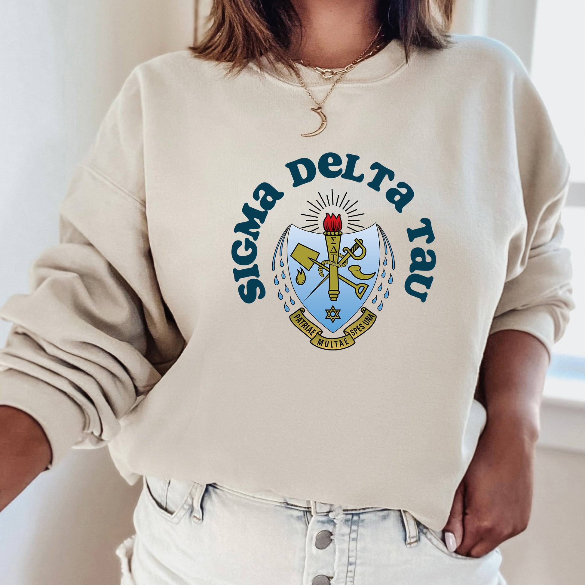 a woman wearing a sweatshirt with a crest on it