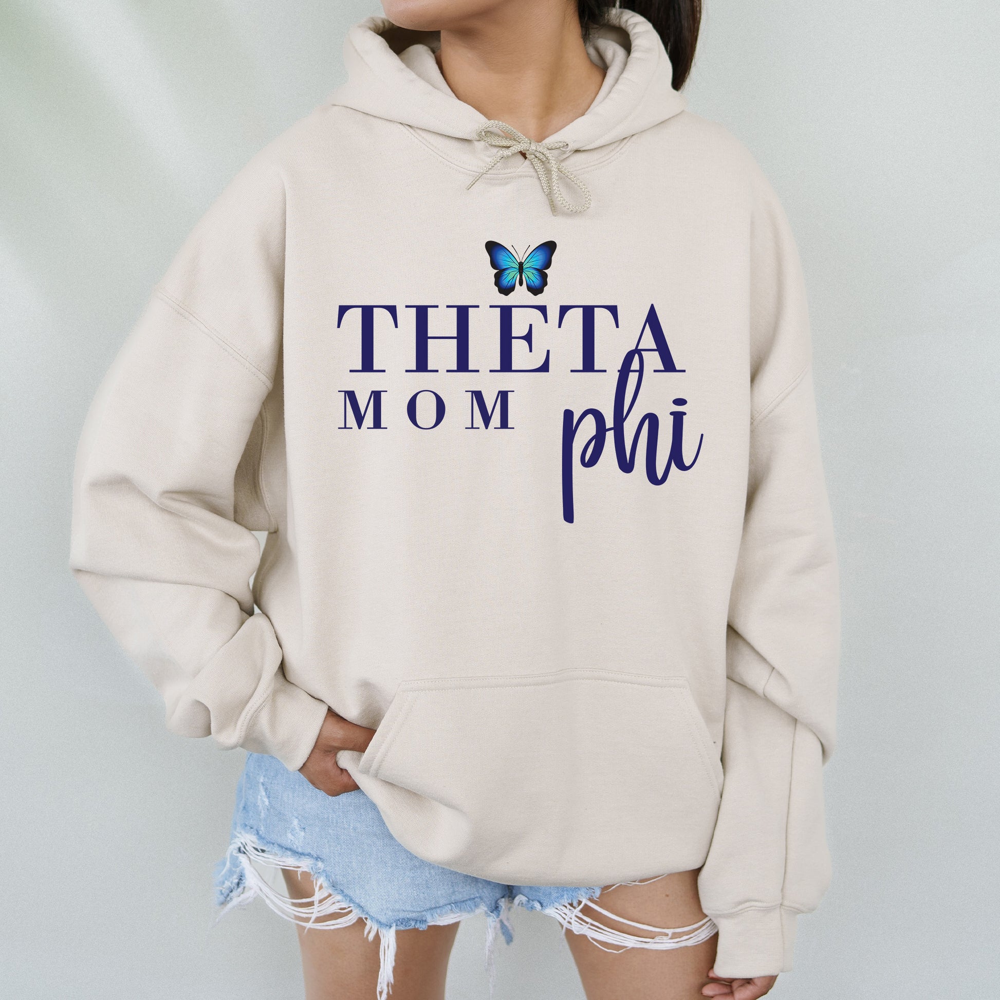 a woman wearing a sweatshirt with a butterfly on it