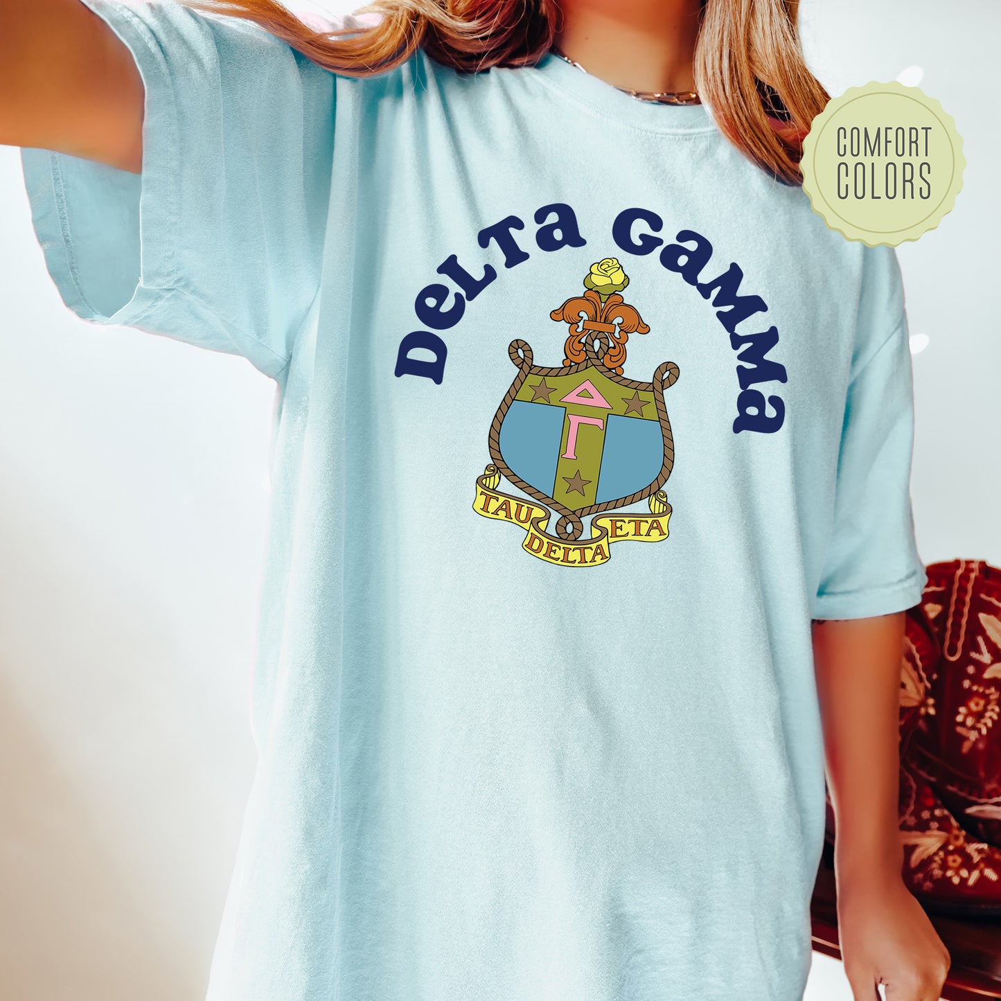 a young girl wearing a blue shirt with a picture of a dog on it