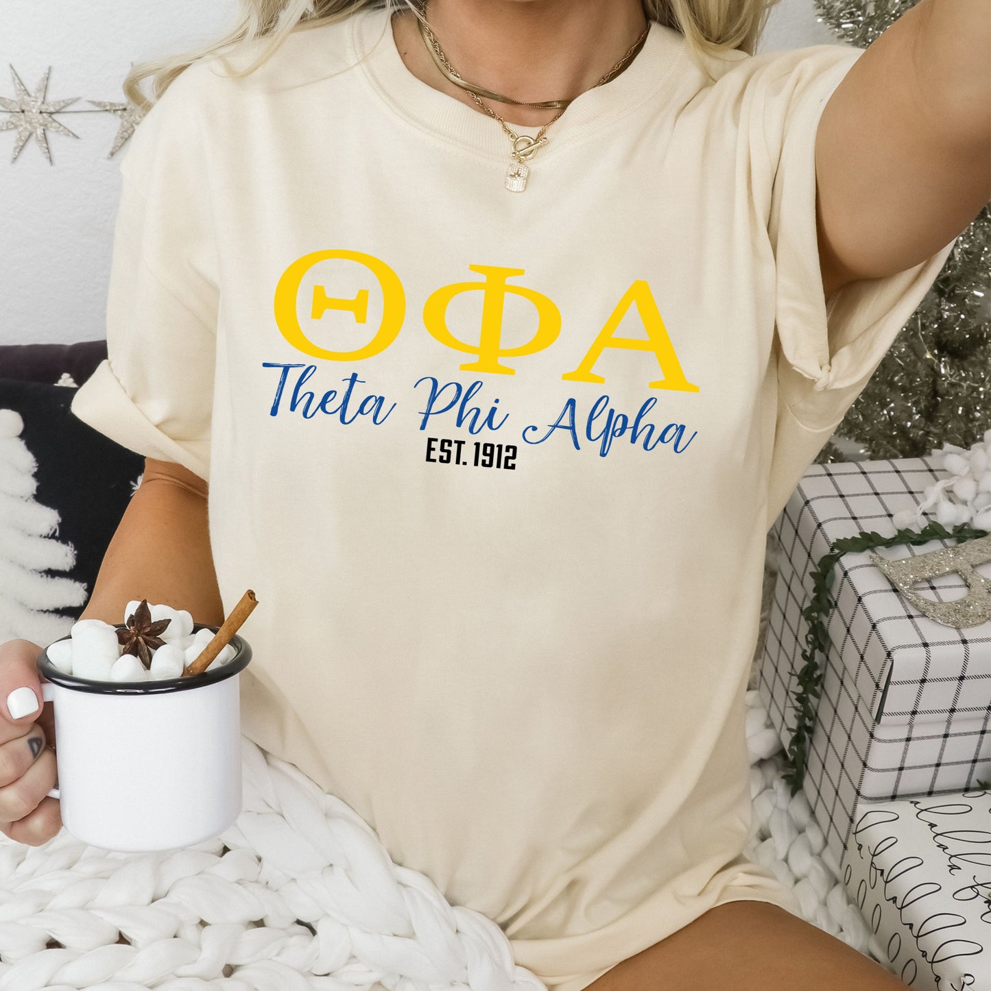 a woman sitting on a bed holding a cup of coffee