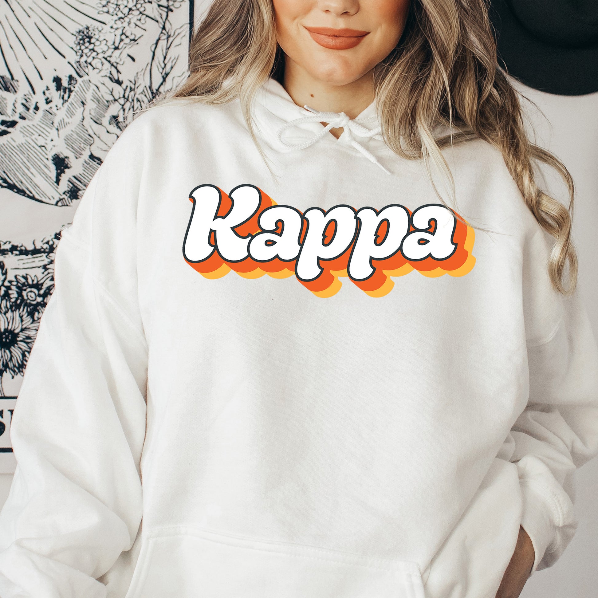 a woman wearing a white hoodie with the word kappe printed on it