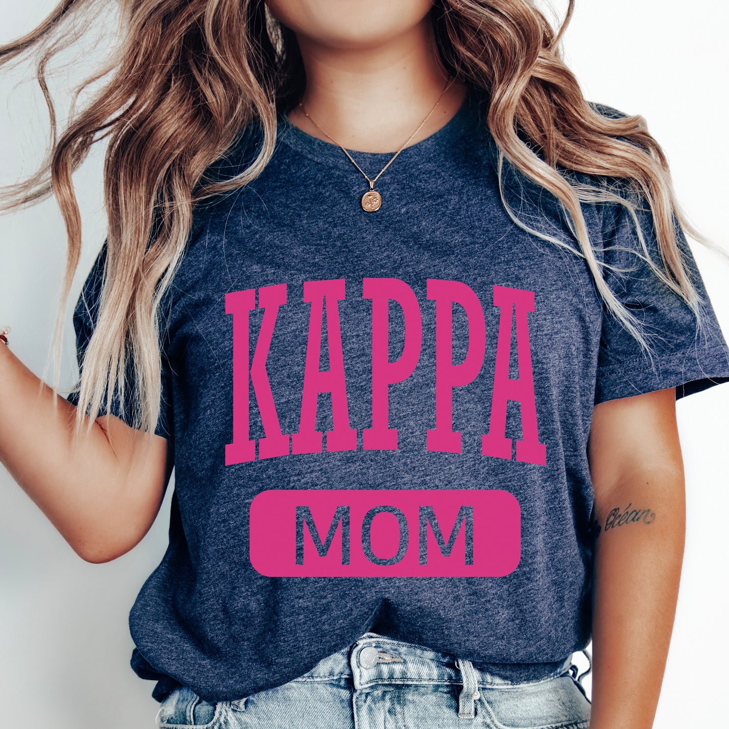 a woman wearing a t - shirt that says kappa mom