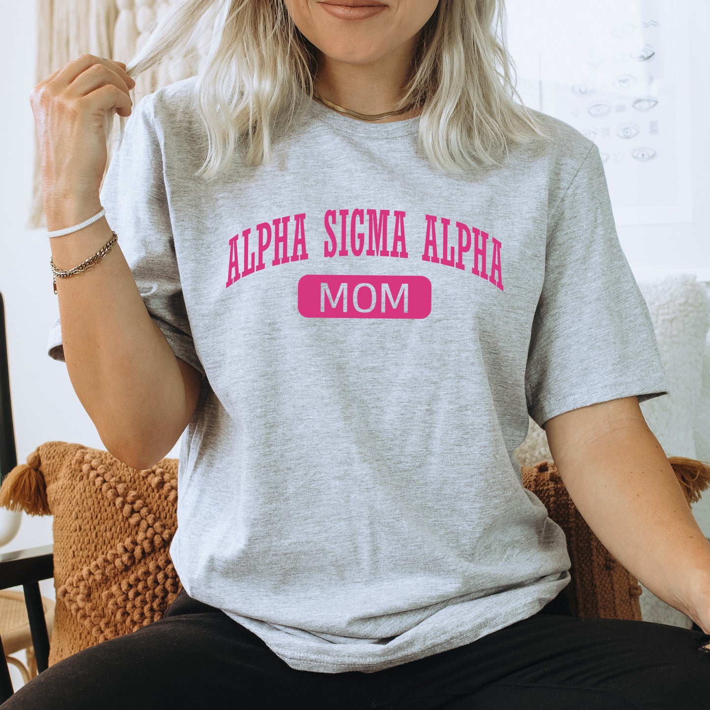 a woman sitting in a chair with a t - shirt on