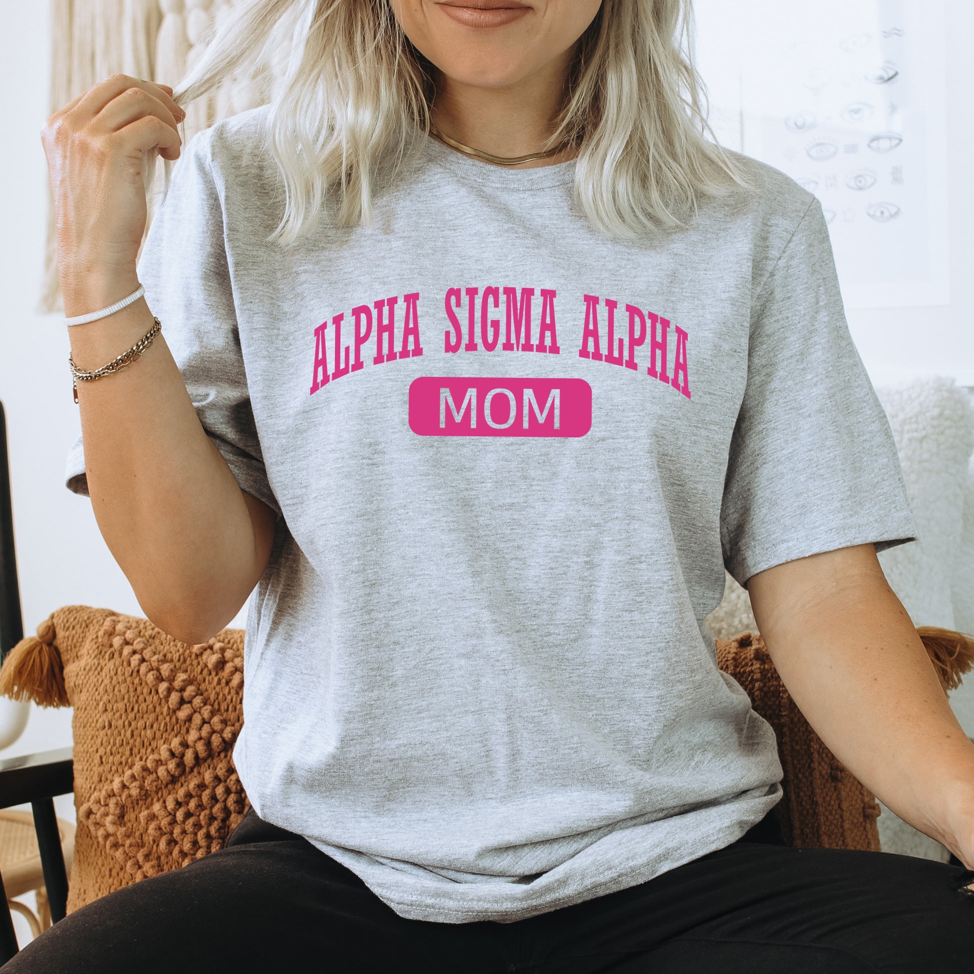 a woman sitting in a chair with a t - shirt on