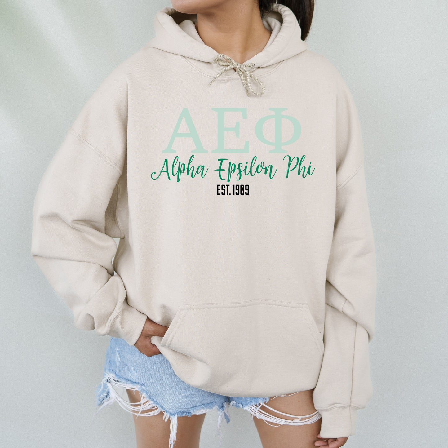 a woman wearing a hoodie with the afq logo on it
