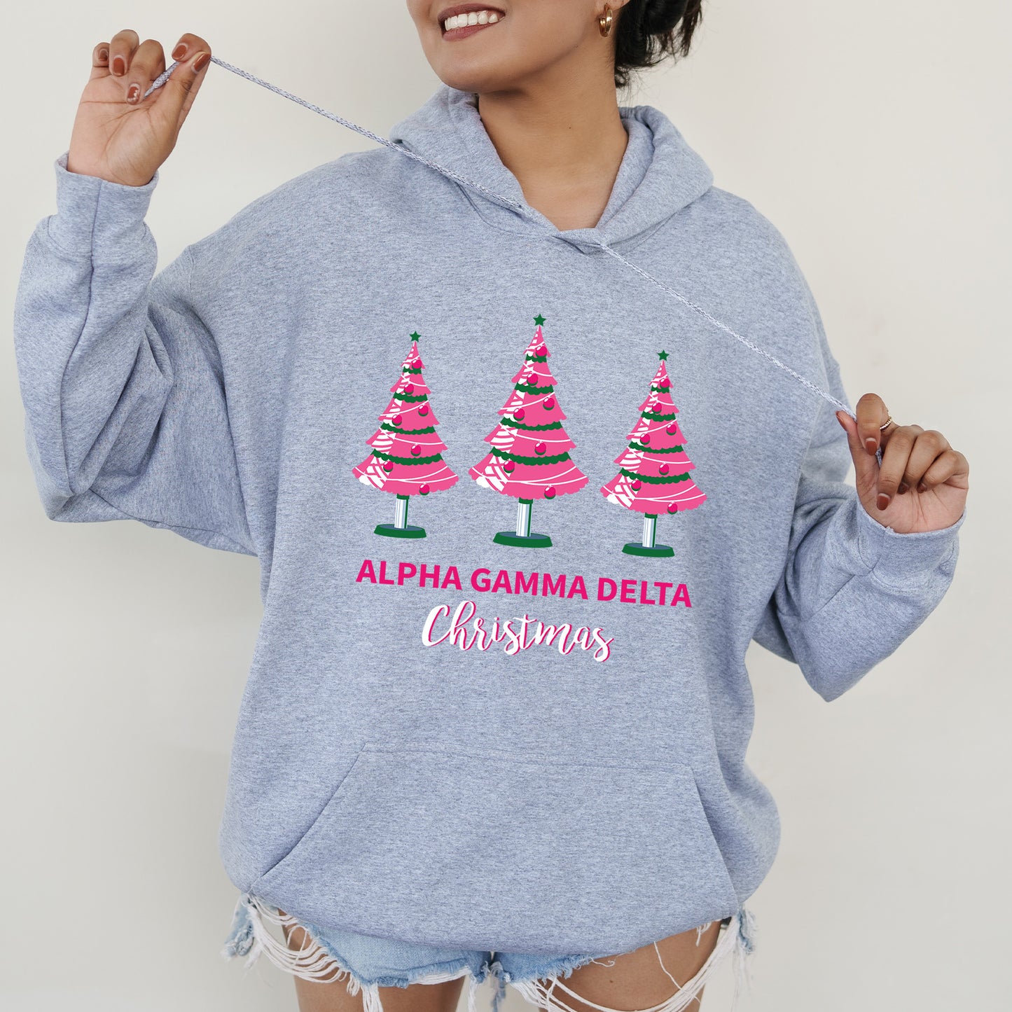 a woman wearing a sweatshirt with christmas trees on it
