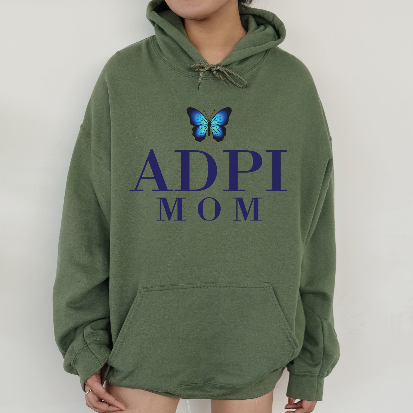 a woman wearing a green hoodie with a butterfly on it