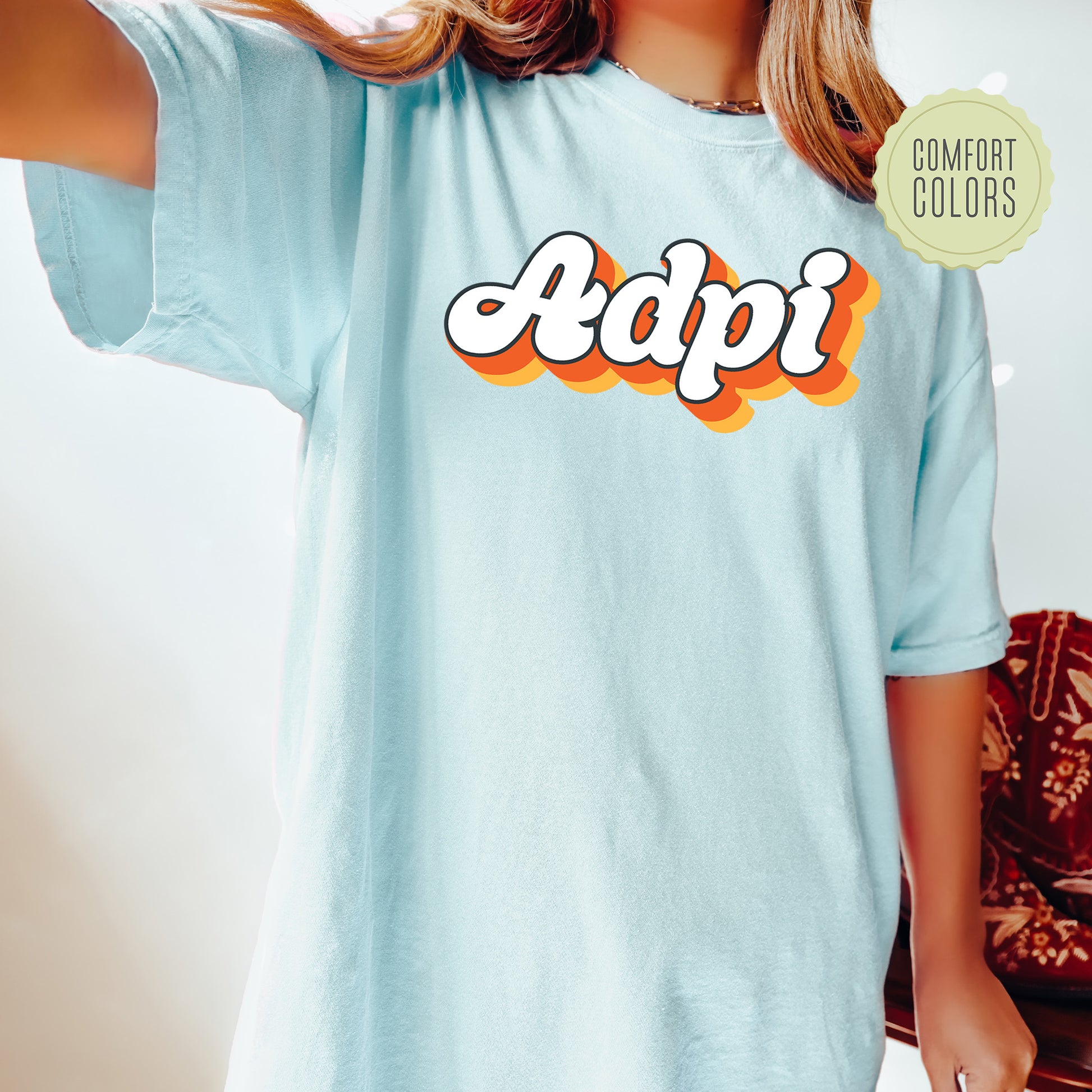 a woman wearing a blue shirt with the word adpi on it