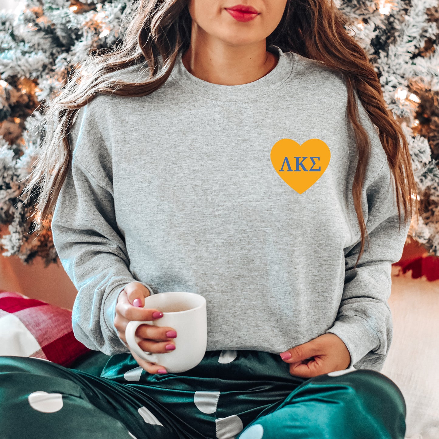 a woman sitting on the floor with a cup of coffee