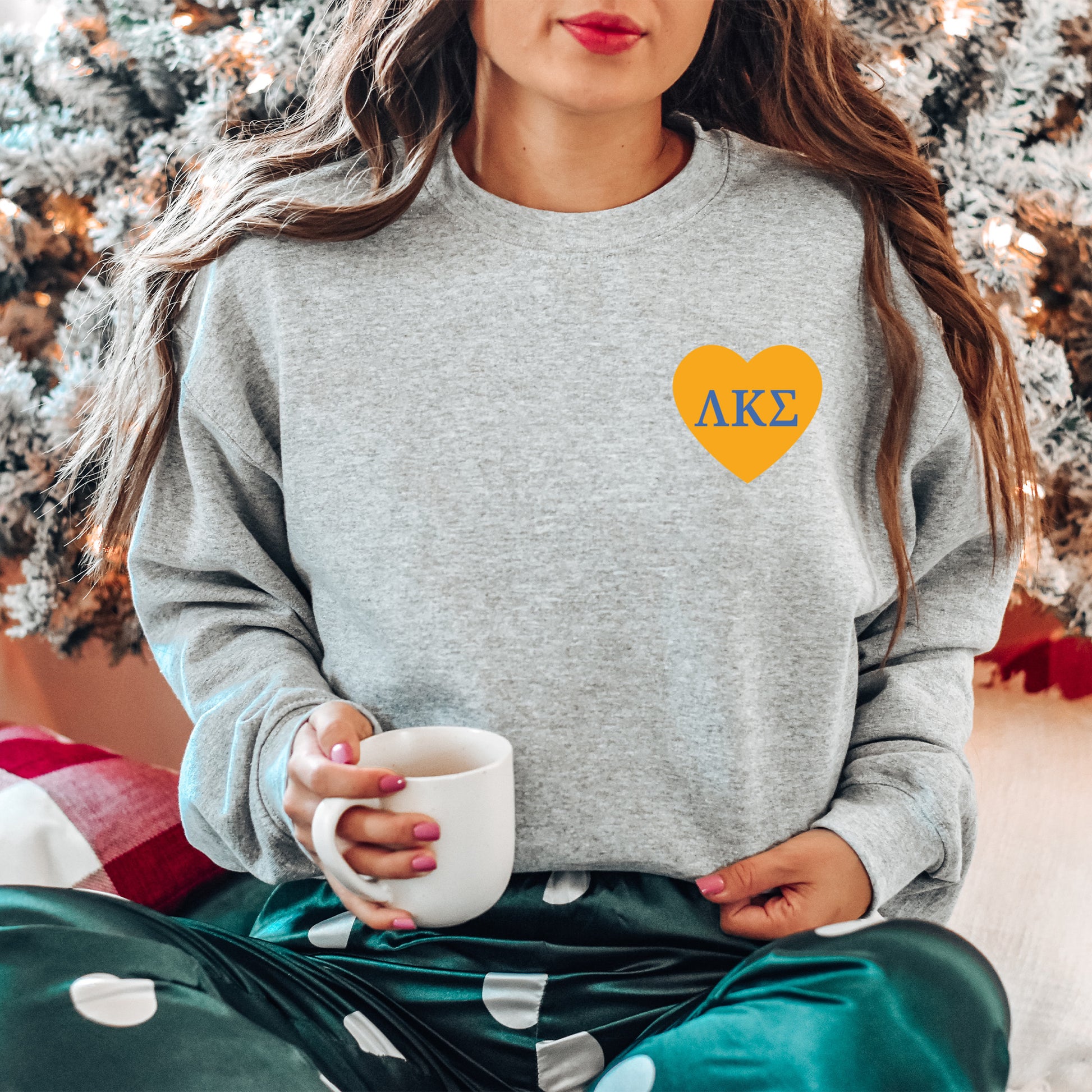 a woman sitting on the floor with a cup of coffee