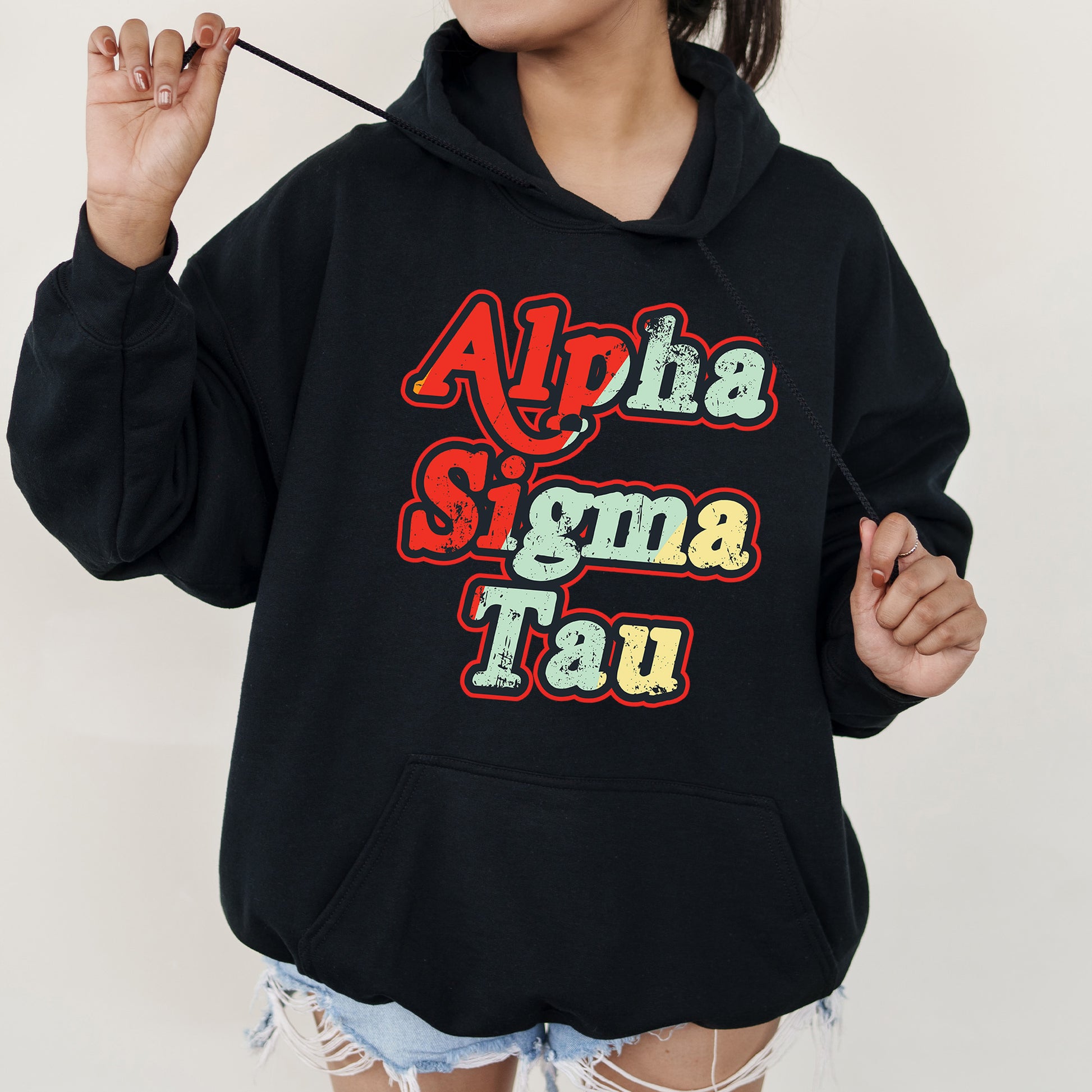 a woman wearing a black hoodie with the words aloha singma tau