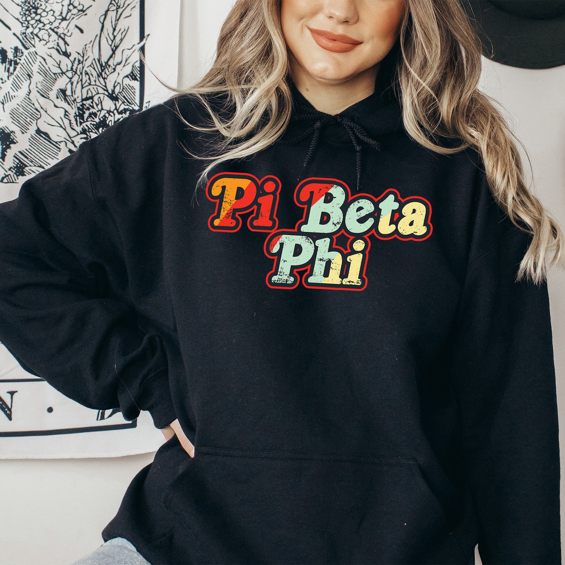 a woman wearing a black hoodie that says pi beta pi