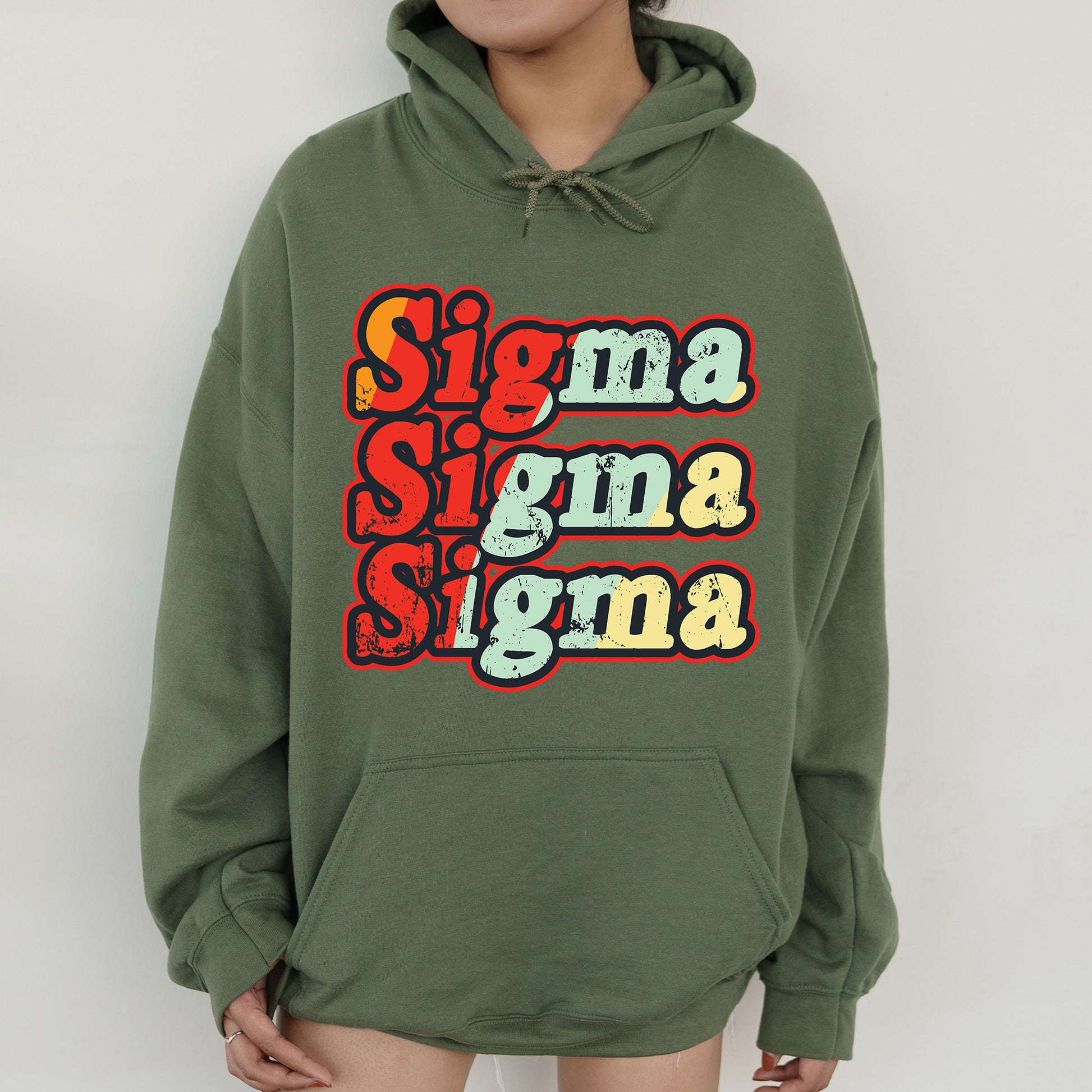 a woman wearing a green hoodie with the words stigma stigma stigma on it