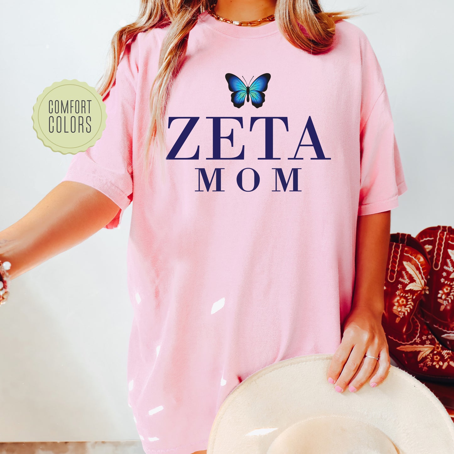 a woman wearing a pink shirt with a butterfly on it