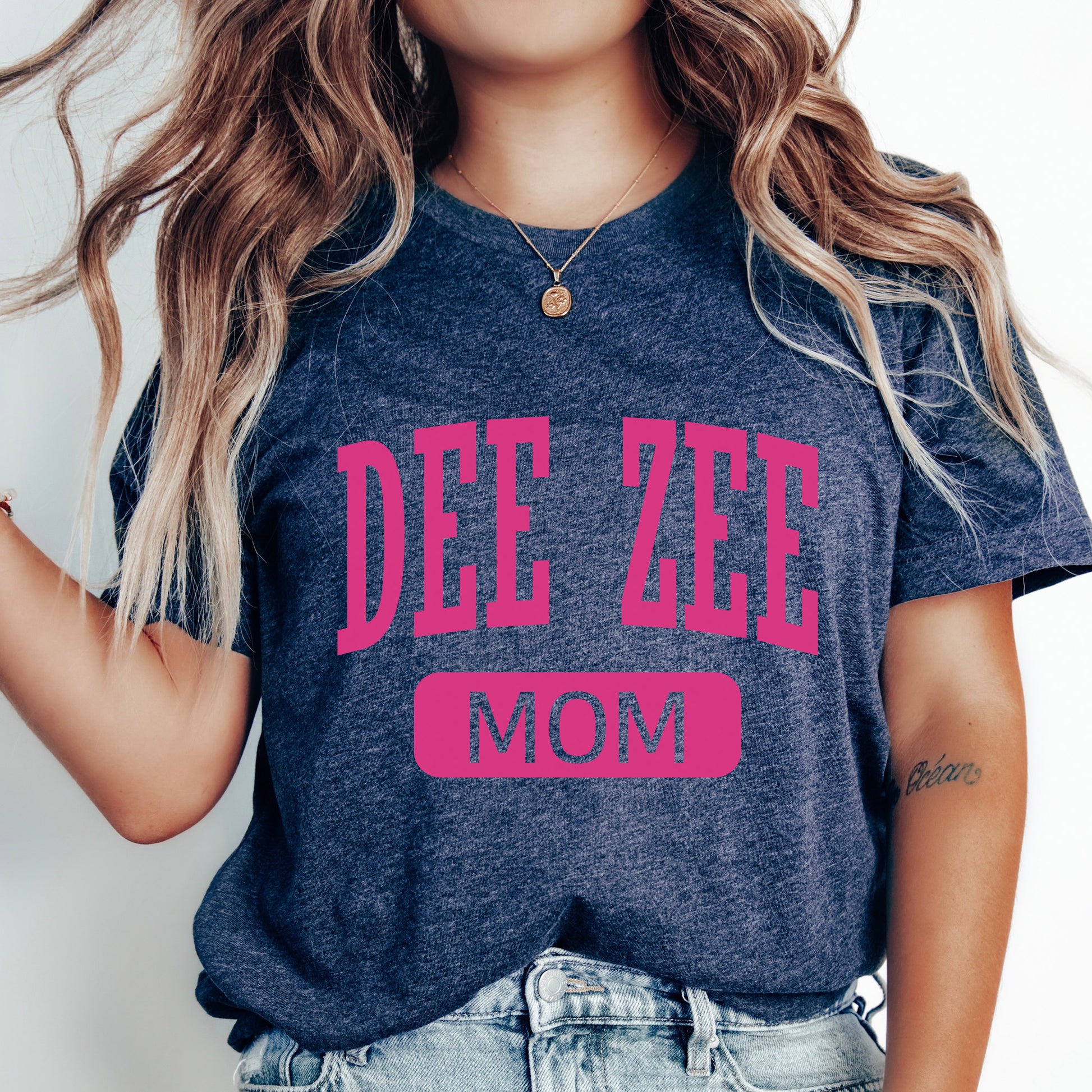 a woman wearing a t - shirt that says dee zee mom