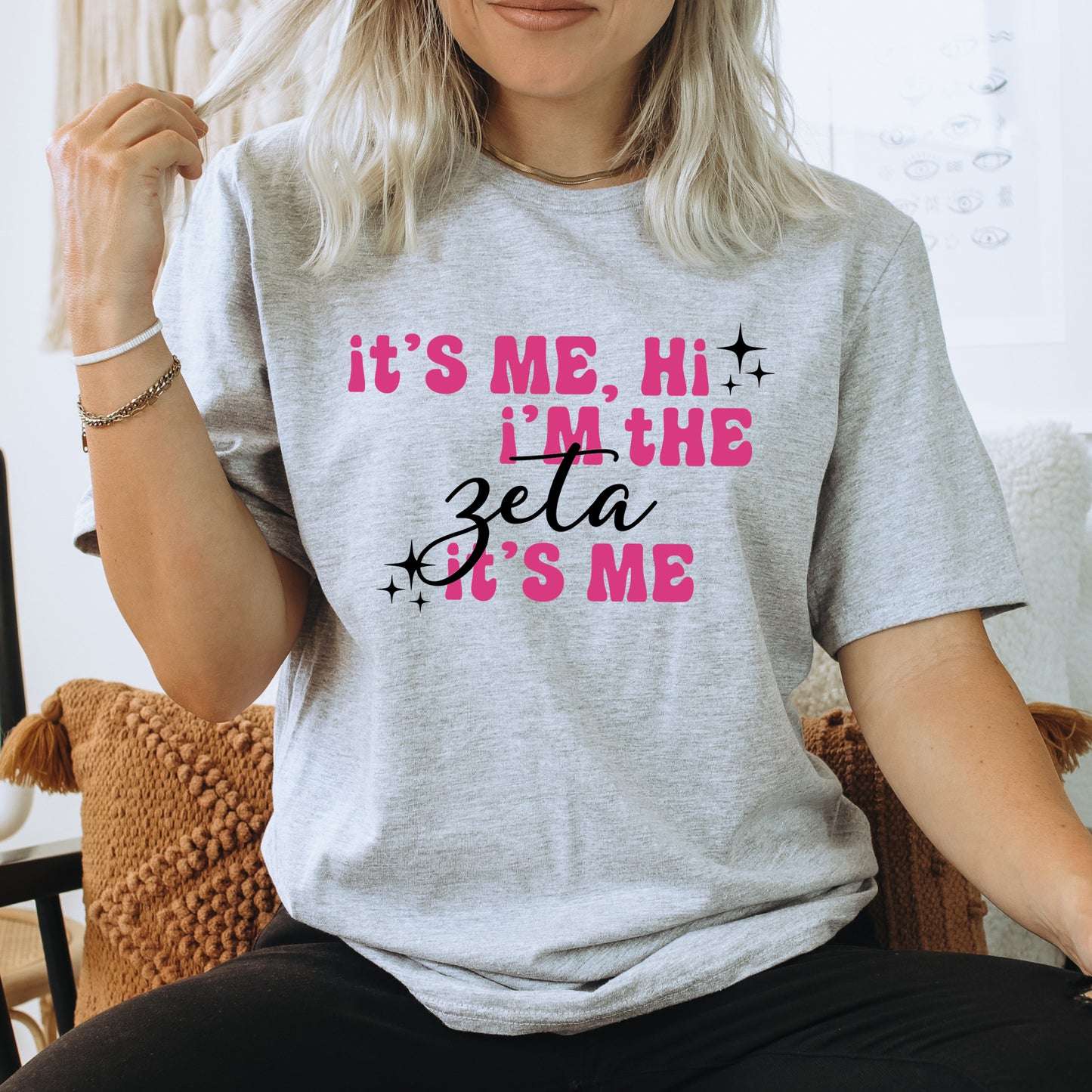 a woman sitting on a chair wearing a t - shirt that says it's