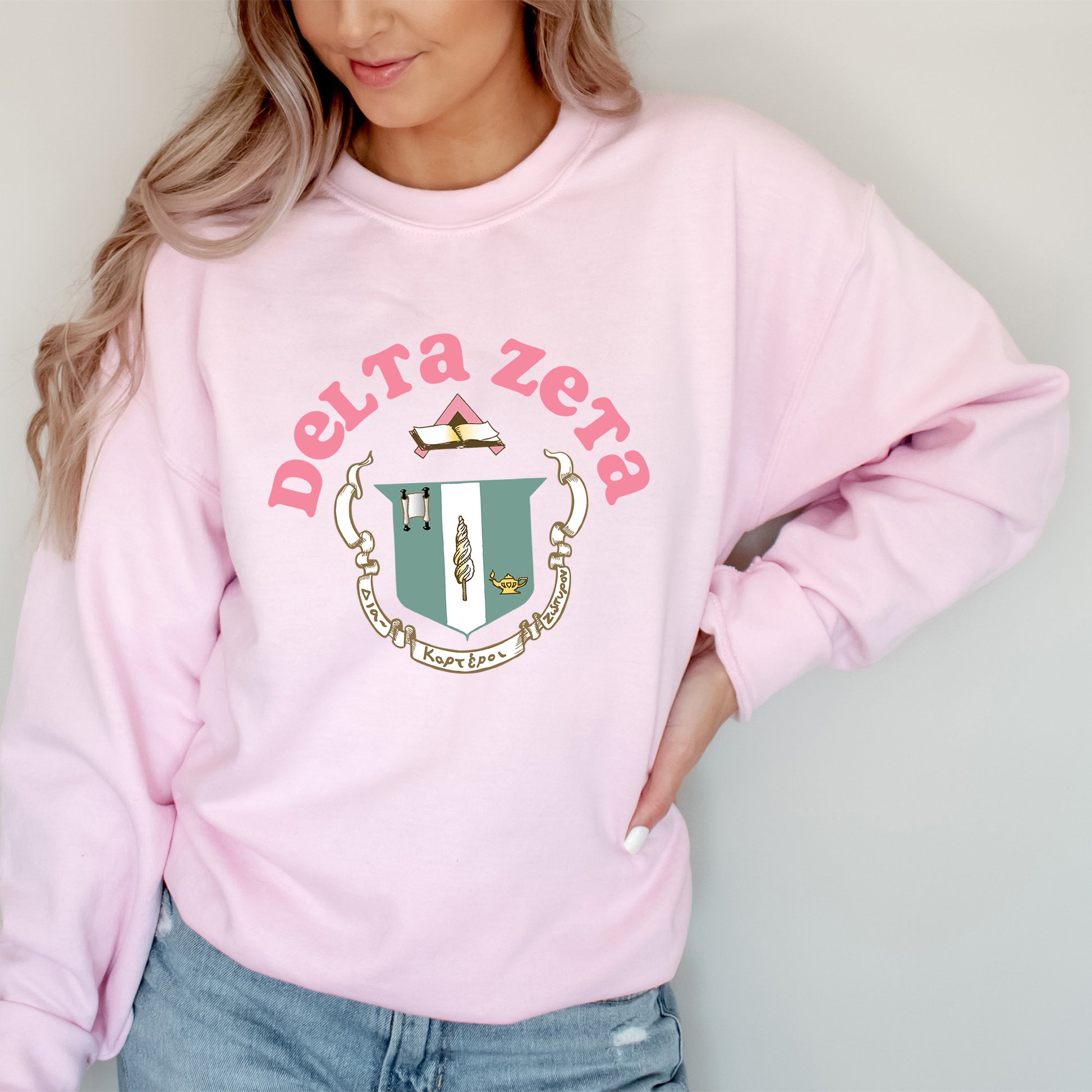 a woman wearing a pink sweatshirt and jeans