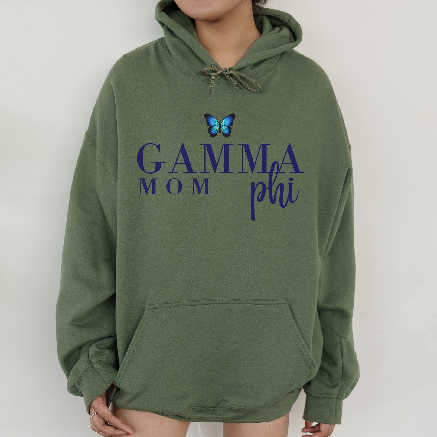 a woman wearing a green hoodie with a butterfly on it