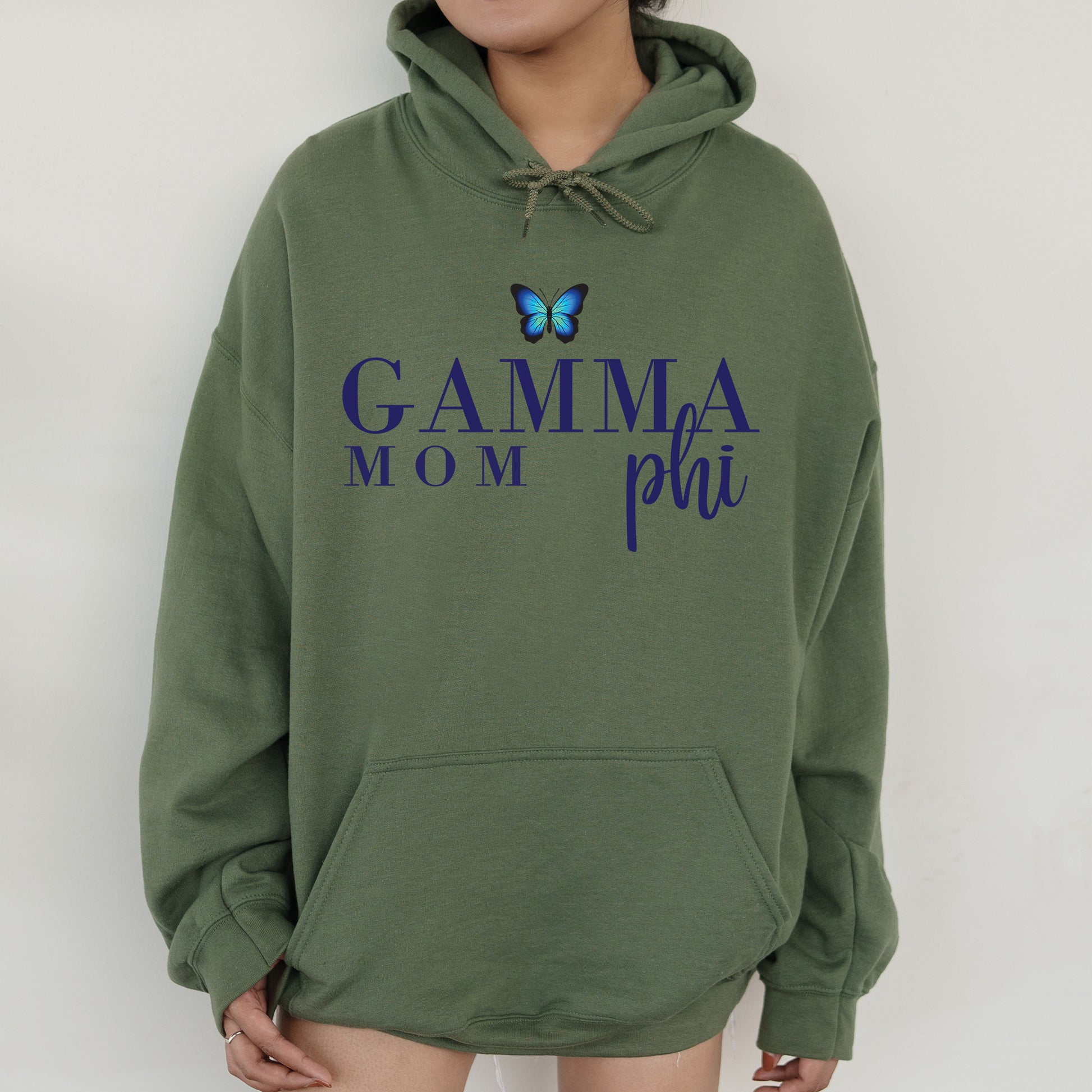 a woman wearing a green hoodie with a butterfly on it
