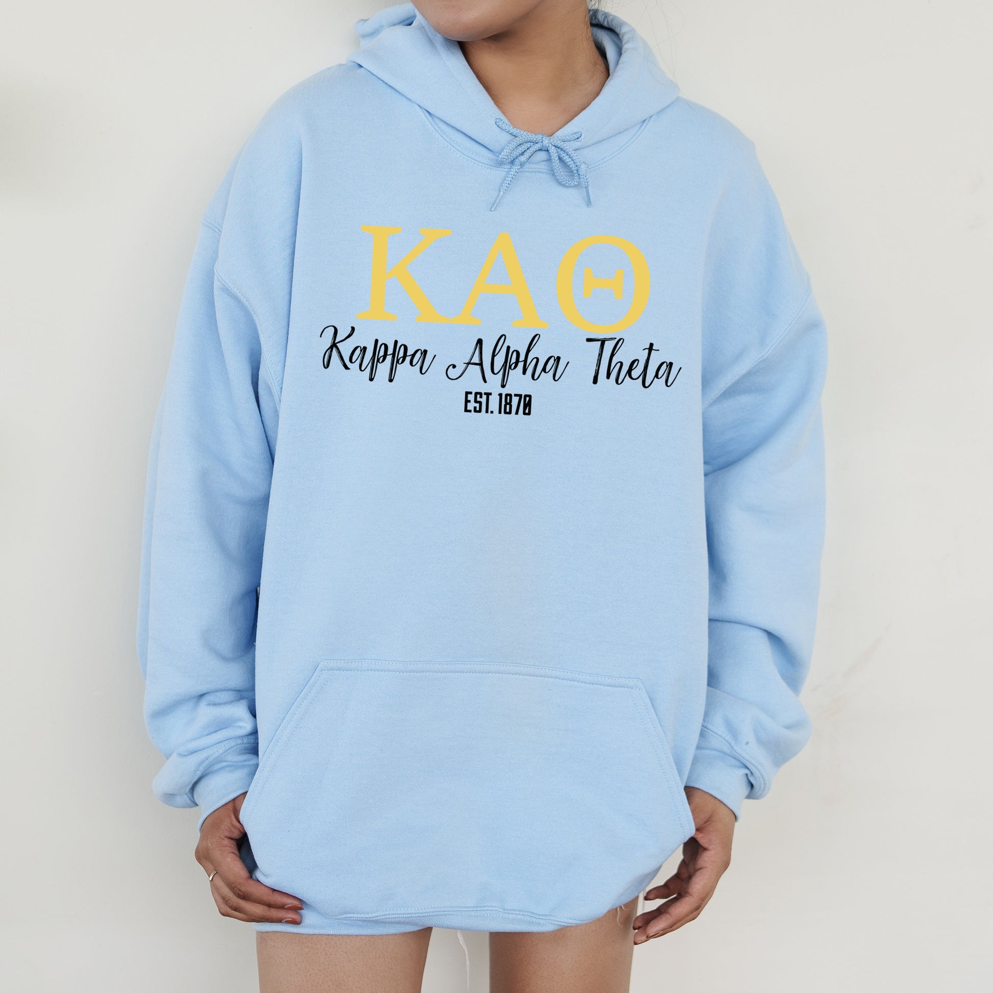 a person wearing a blue hoodie with the words kao on it
