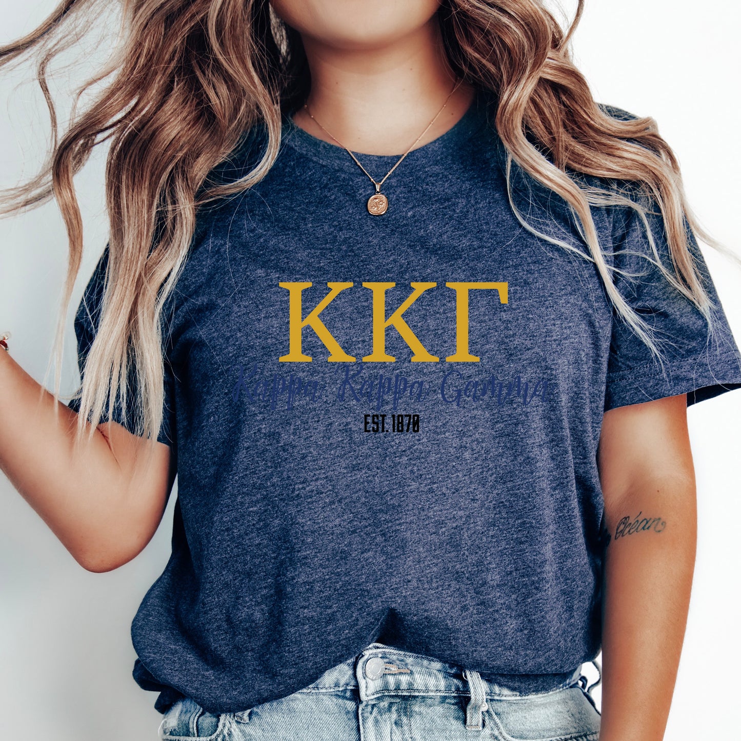 a woman wearing a t - shirt with the letter kkt on it